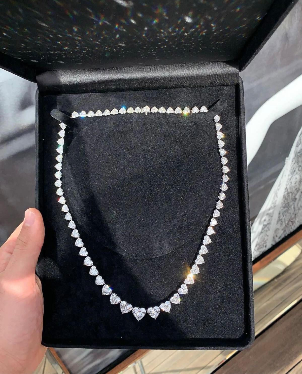 This 70-carat heart-shaped diamond Rivière necklace is a breathtaking expression of luxury, romance, and exquisite craftsmanship. Featuring a graduated design that transitions seamlessly from 3-carat center stones to 1-carat diamonds, this