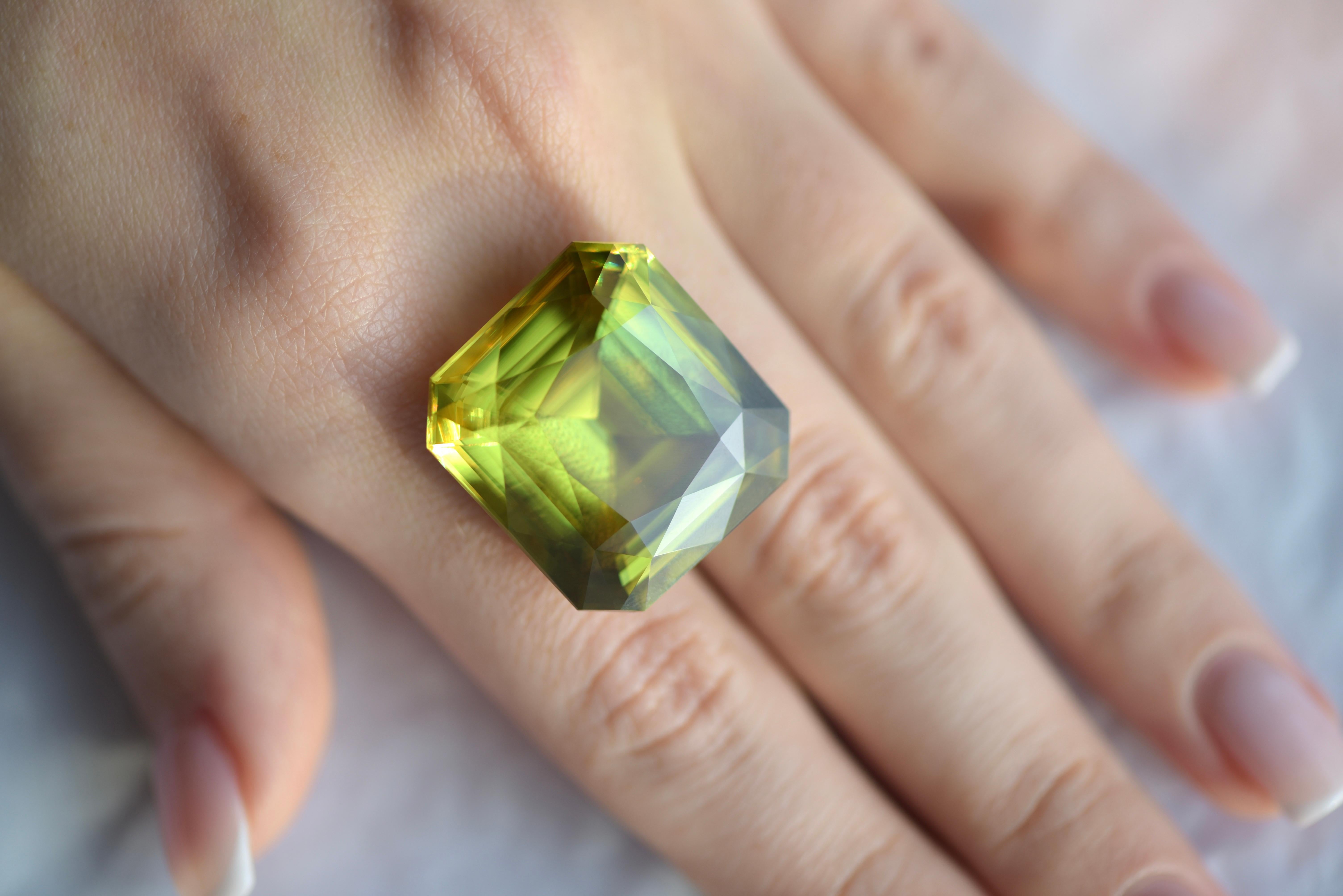 Sphene is a rare mineral that we don't often could find on the gem market. Especially in big sizes. 
It could be green, yellow, brown, almost black. 
We were lucky to find a sphene with bright saturated greenish-olive color, despite the fact that it