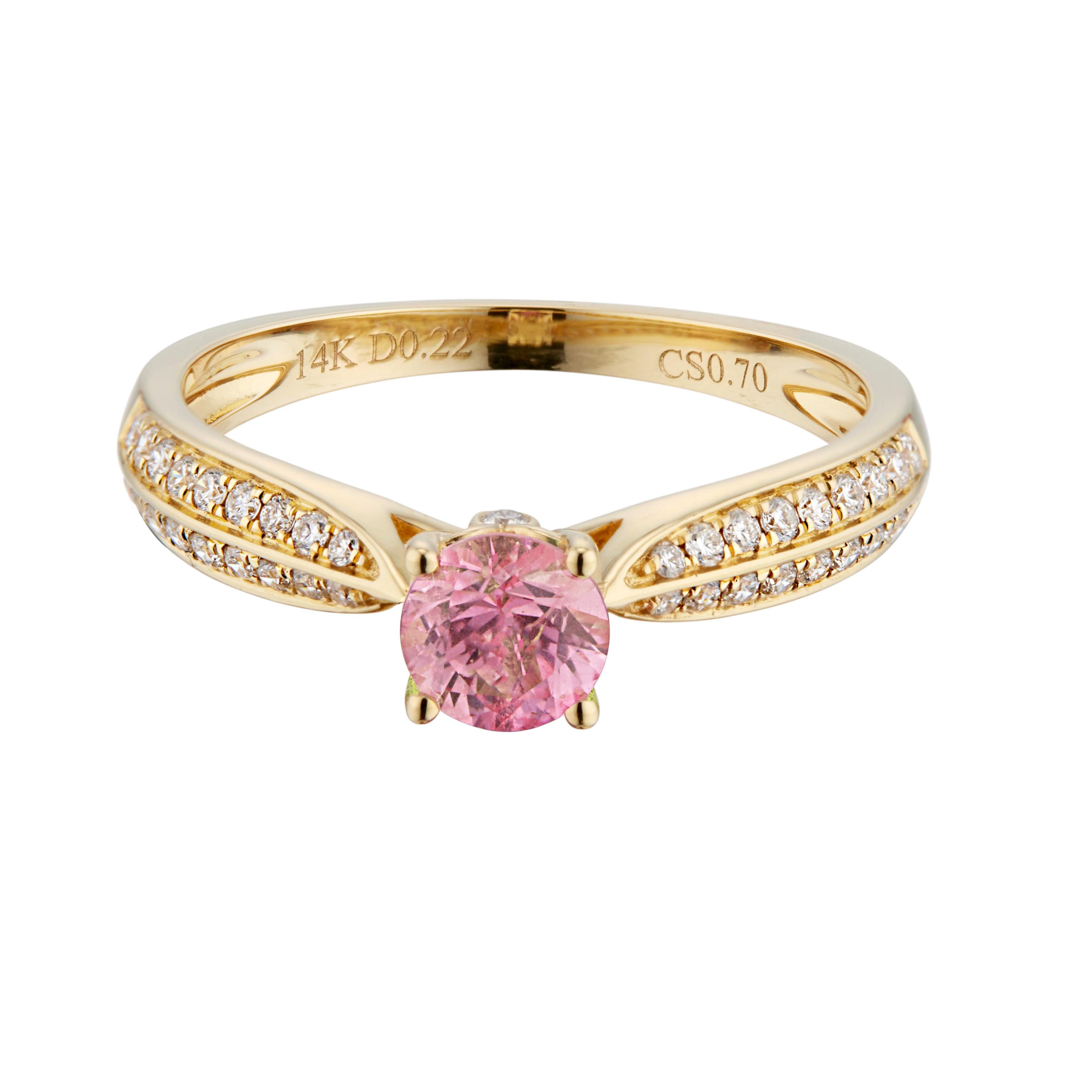 Sapphire and diamond engagement ring. Pink sapphire center stone in a 14k yellow gold solitaire setting, with 38 round brilliant cut diamonds along both sides of the shank. 

1 round pink sapphire, approx. .70cts
38 round brilliant cut diamonds, G