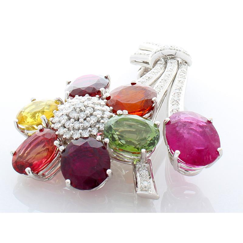 This is the gem brooch! Floral & whimsical was the idea when producing this piece. 7 petals featuring 70.00 carats of multi-colored oval tourmaline adorn this floral design accompanied by 1.90 carats of brilliant diamonds. The details are