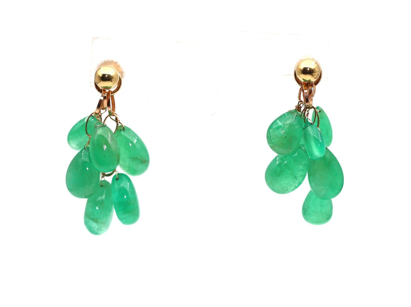 70 Carats Emerald Pear-Shaped Gold Earrings. Created around 1955.

70 Carats of Emeralds freely hanging from the carved Gold ring. The way it moves with the head is just mesmerizing. 
The upper Gold part can be detached and worn separately or even