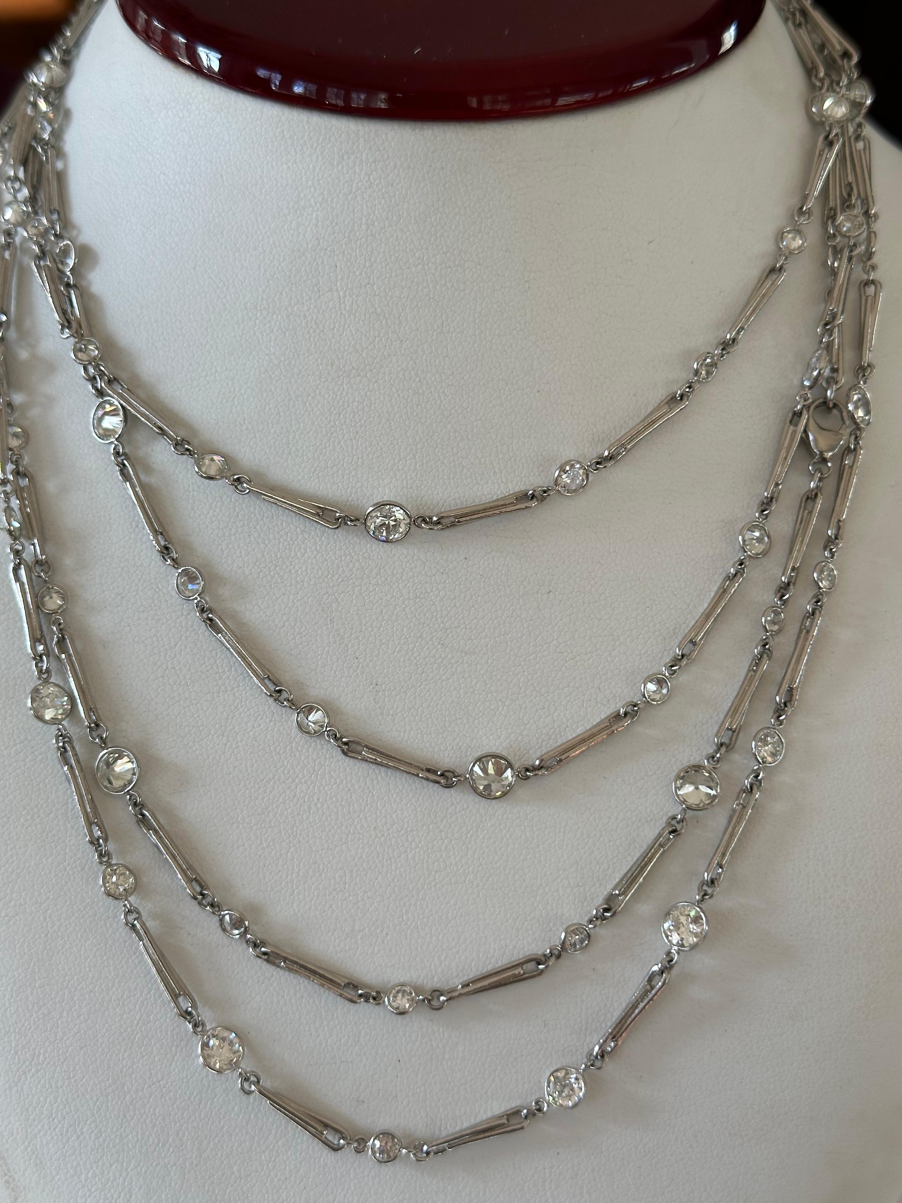 Measuring an impressive 70 inches long, this antique style diamonds-by-the-yard necklace features seventy-six Old European-cut diamonds in varying sizes, GH color, VS clarity, weighing together 20.03 carats. Handcrafted in platinum.  As versatile as