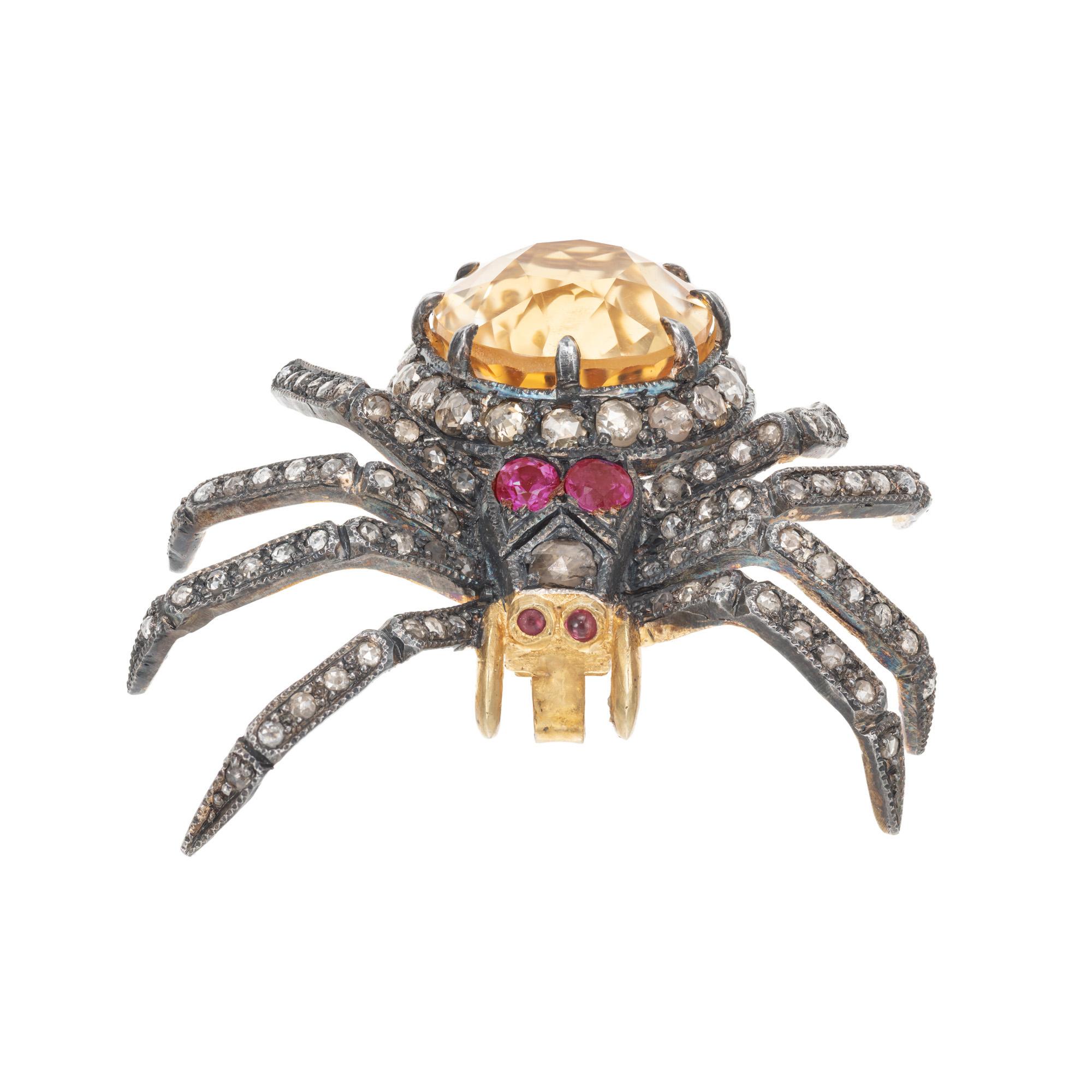 Antique reproduction spider brooch and pendant. Set with 1 oval yellow/orange citrine totaling 7.00cts accented with 2 round pinkish rubies as eyes and 2 cabochon red rubies. 95 rose cut light brown diamonds round out this unique piece. The design