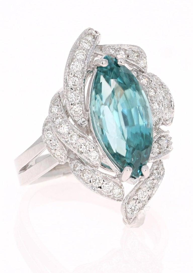 Blue Zircon is a completely NATURAL stone mined in different parts of the world, mainly Sri Lanka, Myanmar, and Australia. 

This Marquise Cut Blue Zircon is 6.50 carats surrounded by 49 Round Cut Diamonds that weigh 0.50 carats. It has a clarity
