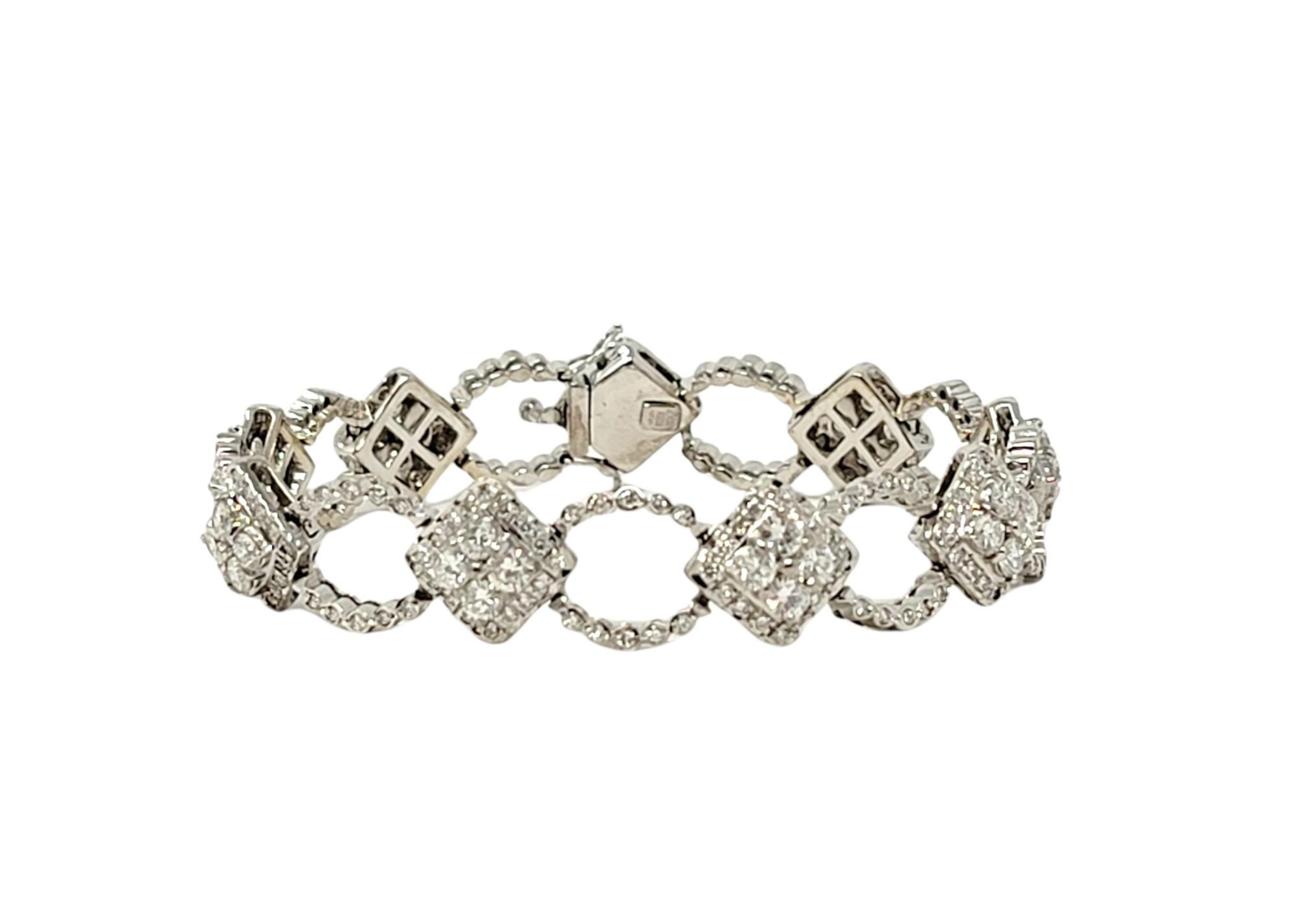 This absolutely gorgeous diamond link bracelet exudes modern elegance and glamour. This stunningly sparkly  piece features oval and diamond shaped 18 karat white gold links set in an alternating pattern throughout. The glittering diamonds sparkle