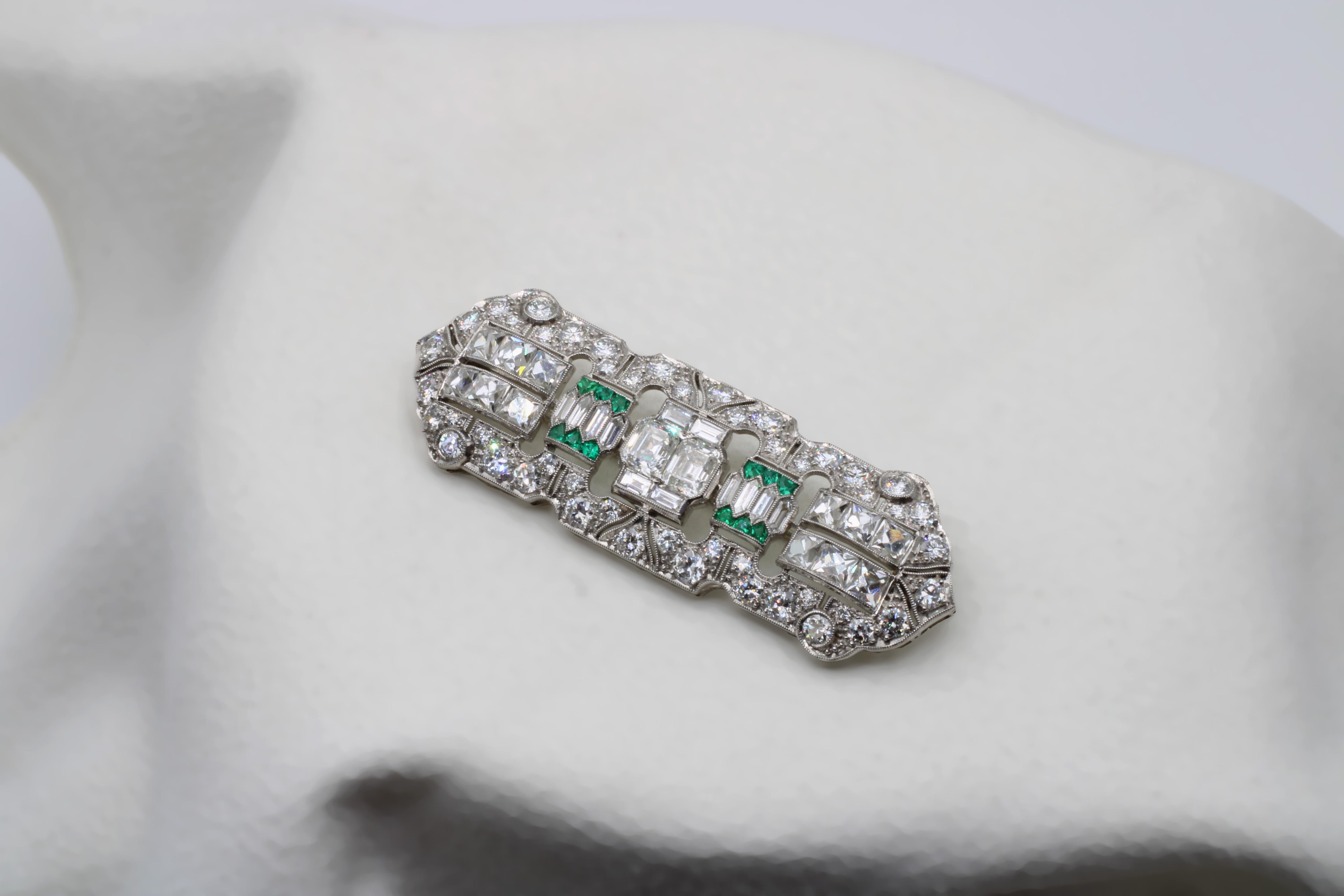 Classic Art Deco brooch combining the breadth of Old Miner, French Cut, Square Cut, and Emerald Cut white diamonds that culminate into the center of the brooch. Piece also features hexagonal emeralds, a rare cut, which -- combined with Old Miners --