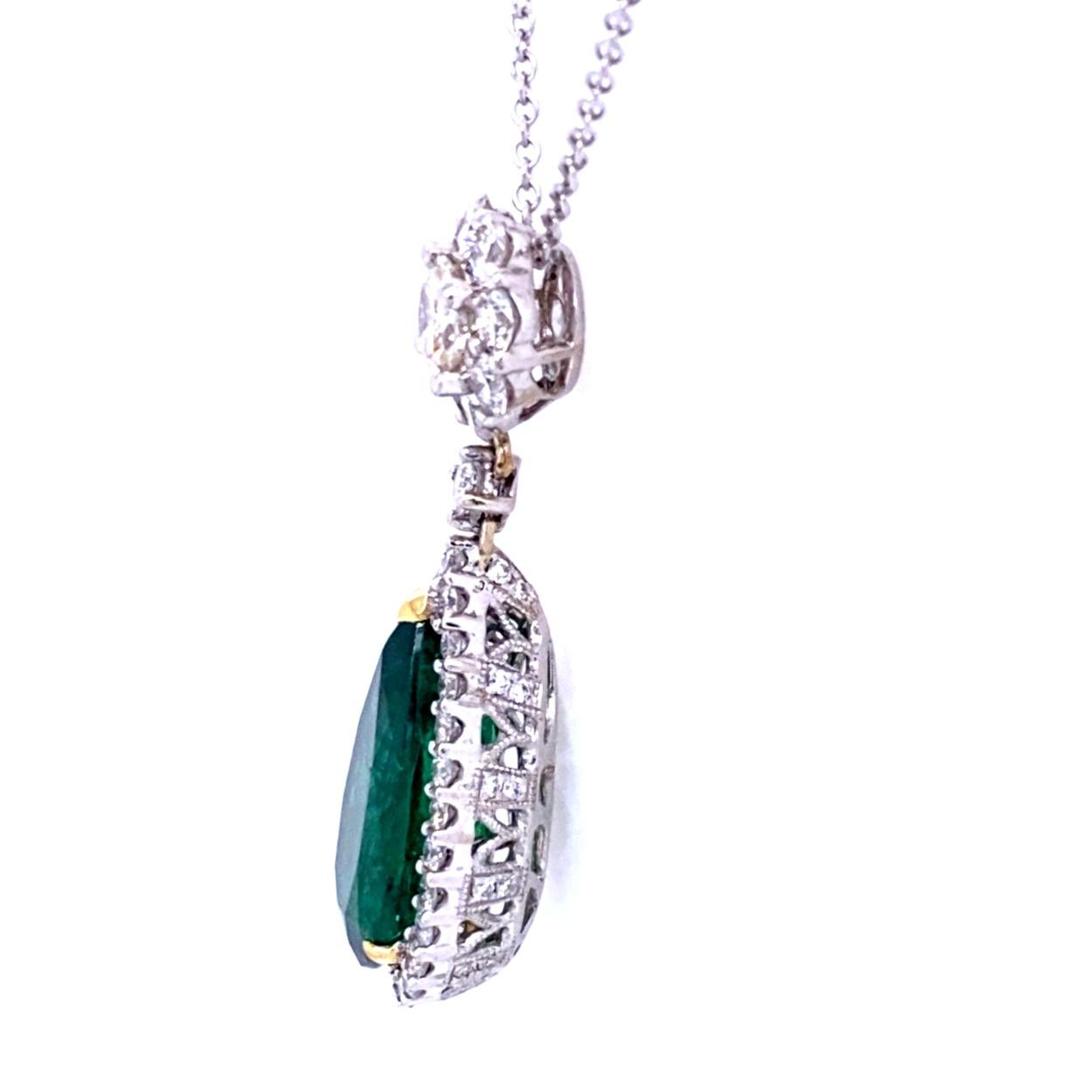 This beautiful 18K Pear Shaped Pendant features a pear shape Emeralds (7.00 Ct) accented by 1.85 Ct of round brilliant diamonds. Look at the back of the earring for the gallery and migraine work to realize the outstanding Craftsmanship that has been