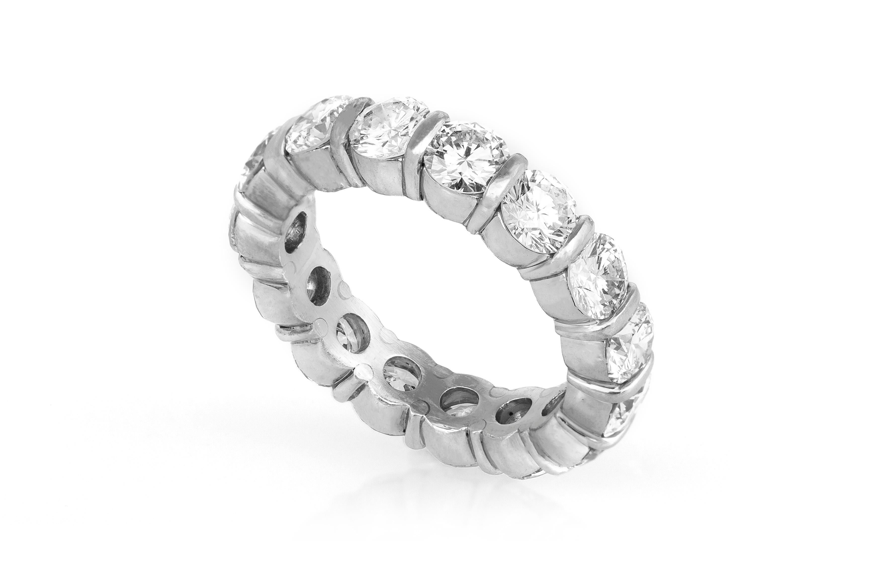 Estate Platinum Eternity Ring features 15 round brilliant cut diamonds, weighing a total of 7.00 carats. Ring Size 8. May be sized upon request, Additional charges may apply. Circa 1990's.