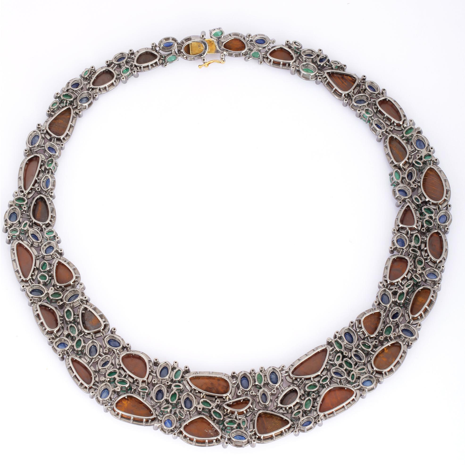 This stunning statement necklace is crafted in 18-karat gold and sterling silver. It is hand set in 70.0 carats opal doublets, 22.65 carats emerald, 27.37 carats blue sapphire and 11.41 carats of diamonds. 

FOLLOW  MEGHNA JEWELS storefront to view
