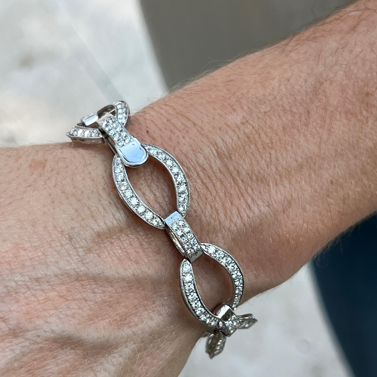 Timeless diamond link bracelet crafted in platinum. The bracelet features round brilliant cut diamond oval links weighing approximately 7.00 carat total weight. The diamonds are graded F-G color and VS clarity. The bracelet features milgrain edging