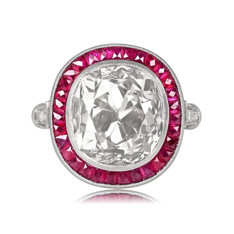 A captivating diamond and ruby halo ring features a 7-carat antique cushion-cut diamond with L color and VS1 clarity at its center. The diamond is surrounded by a halo of calibrated French-cut natural rubies and further complemented by additional