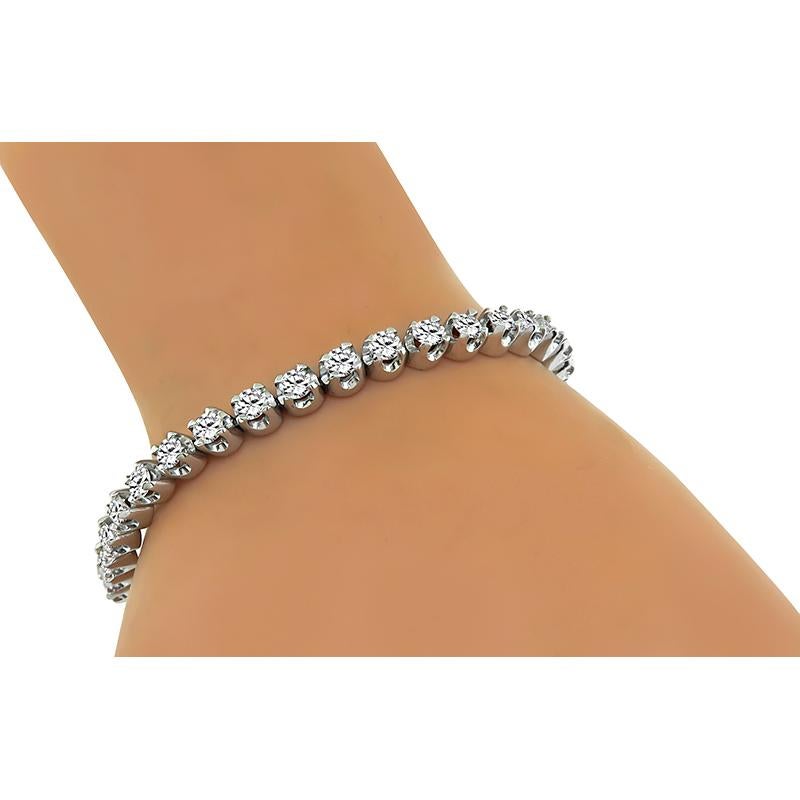 This is a stunning 14k white gold tennis bracelet. The bracelet is set with sparkling round cut diamonds that weigh approximately 7.00ct. The color of these diamonds is G with VS2 clarity. The bracelet measures 5mm in width and 7 1/4 inches in