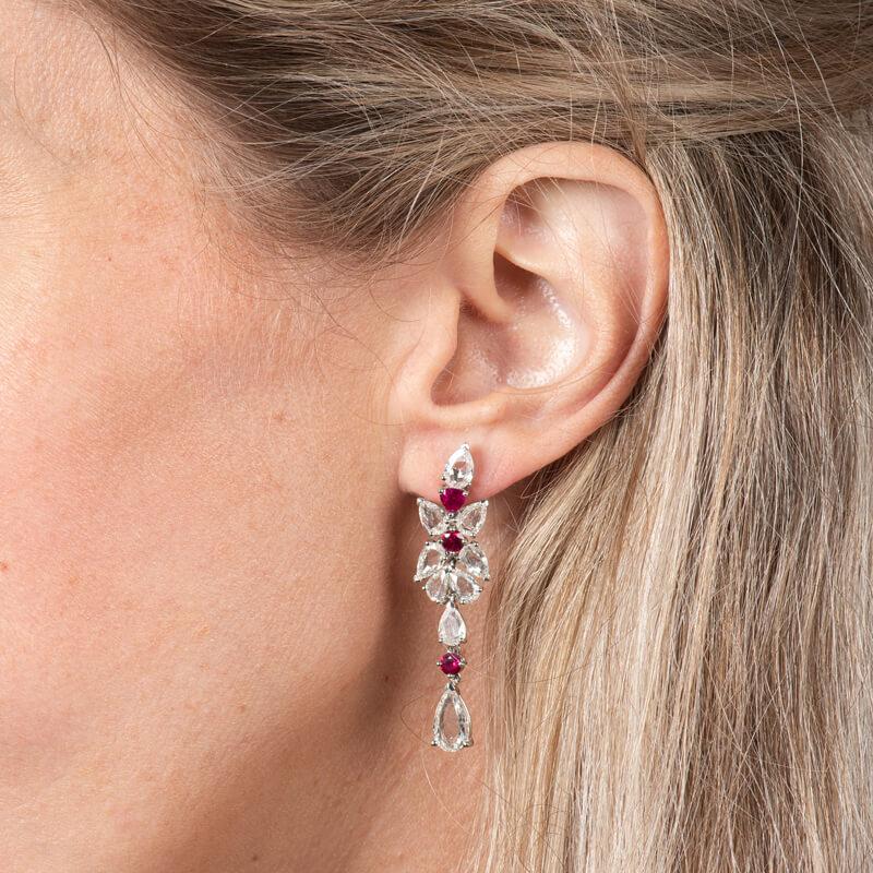 These magnificent drop earrings shine from every angle and feature 7.00ct total weight in rose cut diamonds and 1.25ct total weight in rubies set in 18 karat white gold. Jumbo butterfly back. 
Measurements: Length approximately 1.75