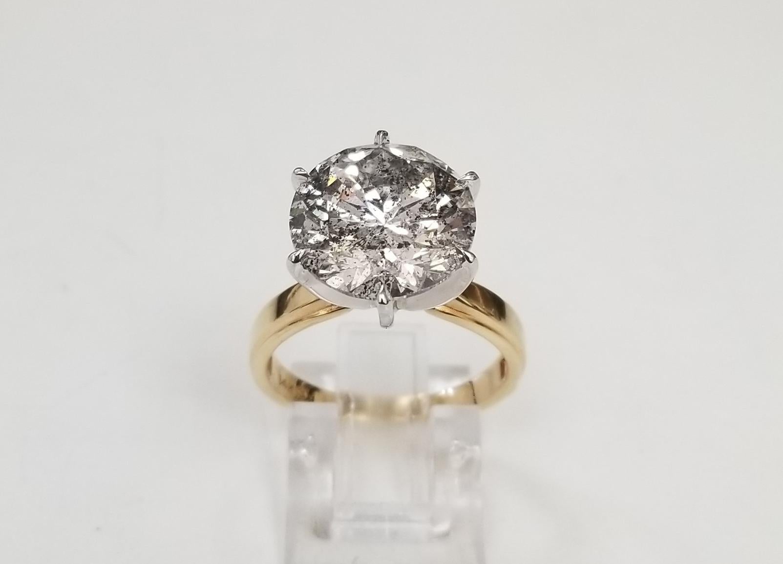 
This is a lot of bling for a little amount of money, look at the life of the diamond. 7.01 carat Brilliant cut Diamond set in a 14k gold 6 prong Tiffany solitaire; color G, clarity SI1-I1 and weight 7.01 (12.2mm). ring is a size 7