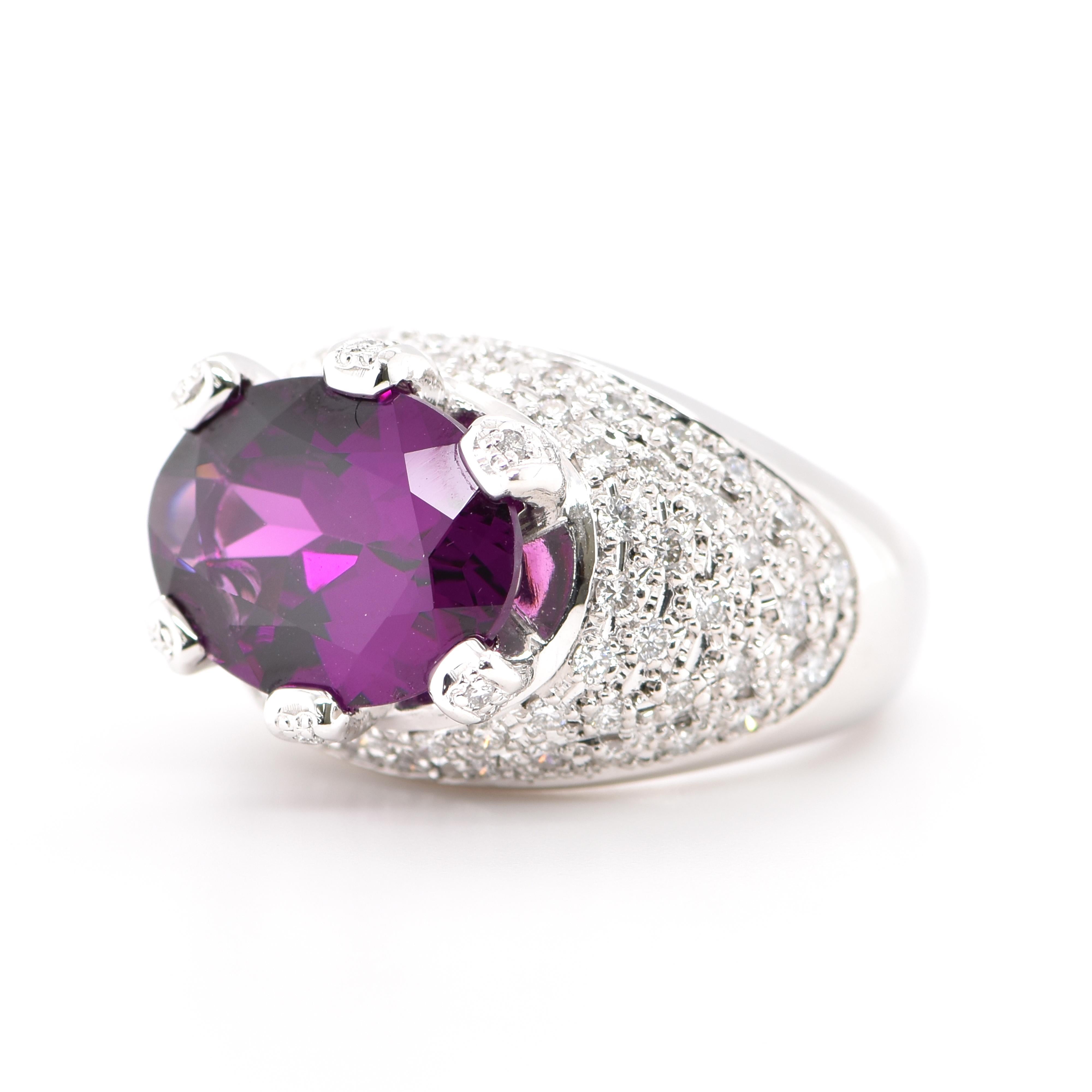 An absolutely gorgeous Cocktail Ring featuring a 7.01 Carat Natural Rhodolite Garnet and 0.96 Carats of Diamond Accents set in Platinum. Garnets have been adorned by humans throughout history from Ancient Egypt, Rome and Greece. They come in a wide