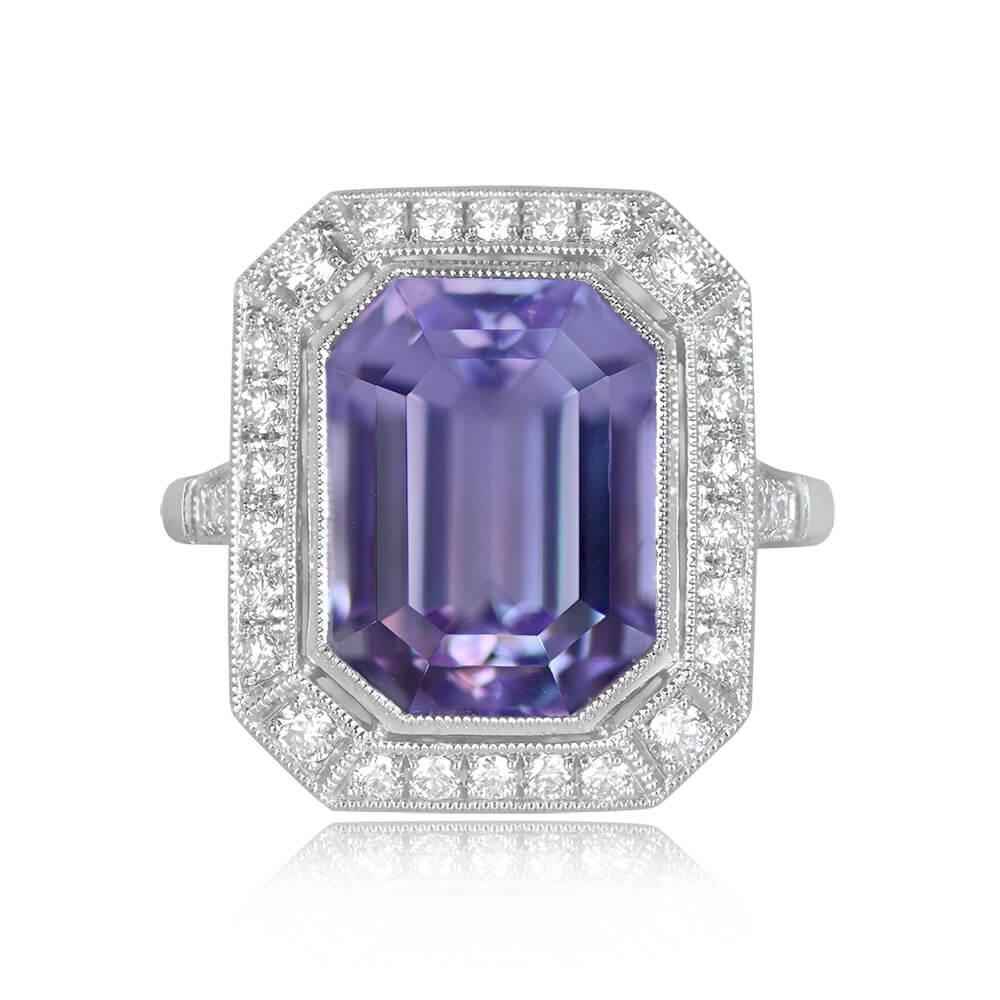 A captivating geometric ring showcases a vibrant 7.01-carat emerald-cut natural kunzite with pink saturation. The center stone is embraced by a halo of pave-set round brilliant-cut diamonds. The shoulders also feature round brilliant cut diamonds,