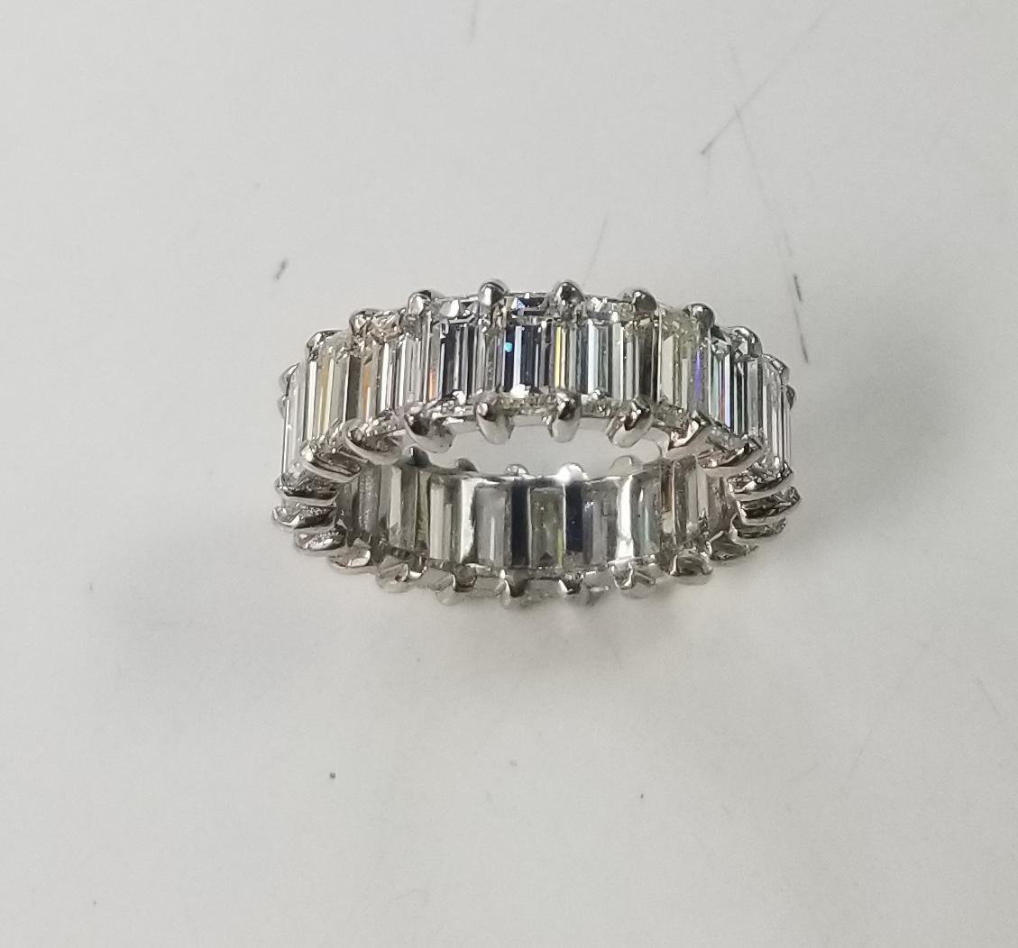 A breathtakingly beautiful diamond wedding band featuring 22 baguette cut diamonds set in platinum weighing 7.02carats. These spectacular diamonds are F-G in color, VS1-2  clarity. This seamless eternity band is expertly crafted surely will catch