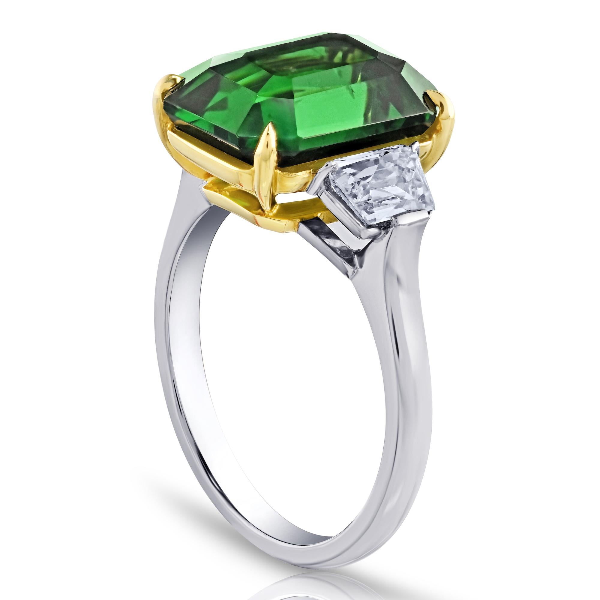 7.02 carat Emerald Green Tsavorite with French Cut Trapezoid Diamonds weighing .86 carats set in a Platinum and 18k Yellow Gold ring.