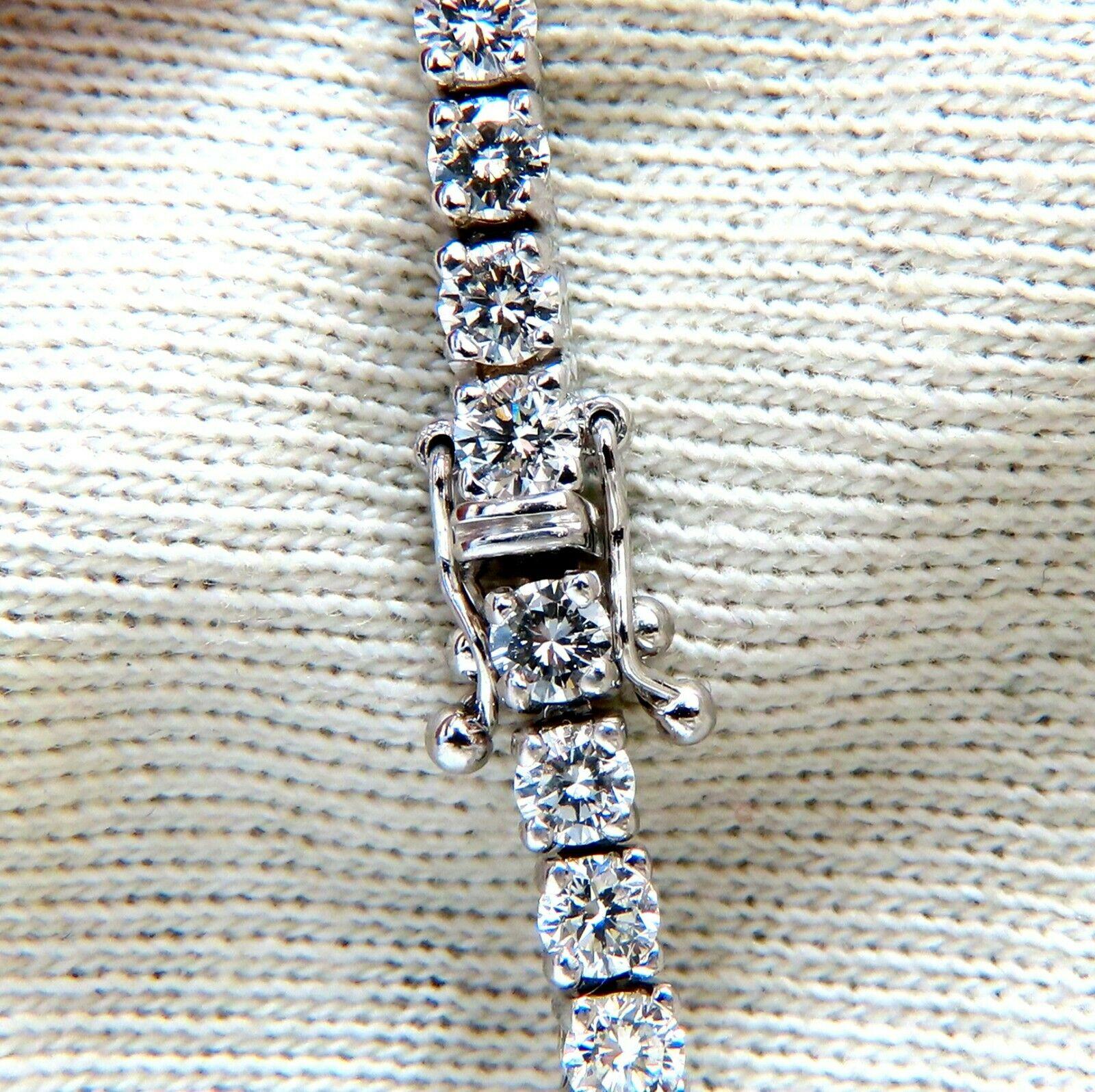 Classic Tennis

7.02ct. Natural  diamonds bracelet.

Round, full cuts 

G color 

Vs-2 clarity.

18kt. white gold 

15.1 Grams.

Width of bracelet: 3.2mm

7.25 inch length

double safety clasp/ double snap lock

$22,000 Appraisal Certificate will