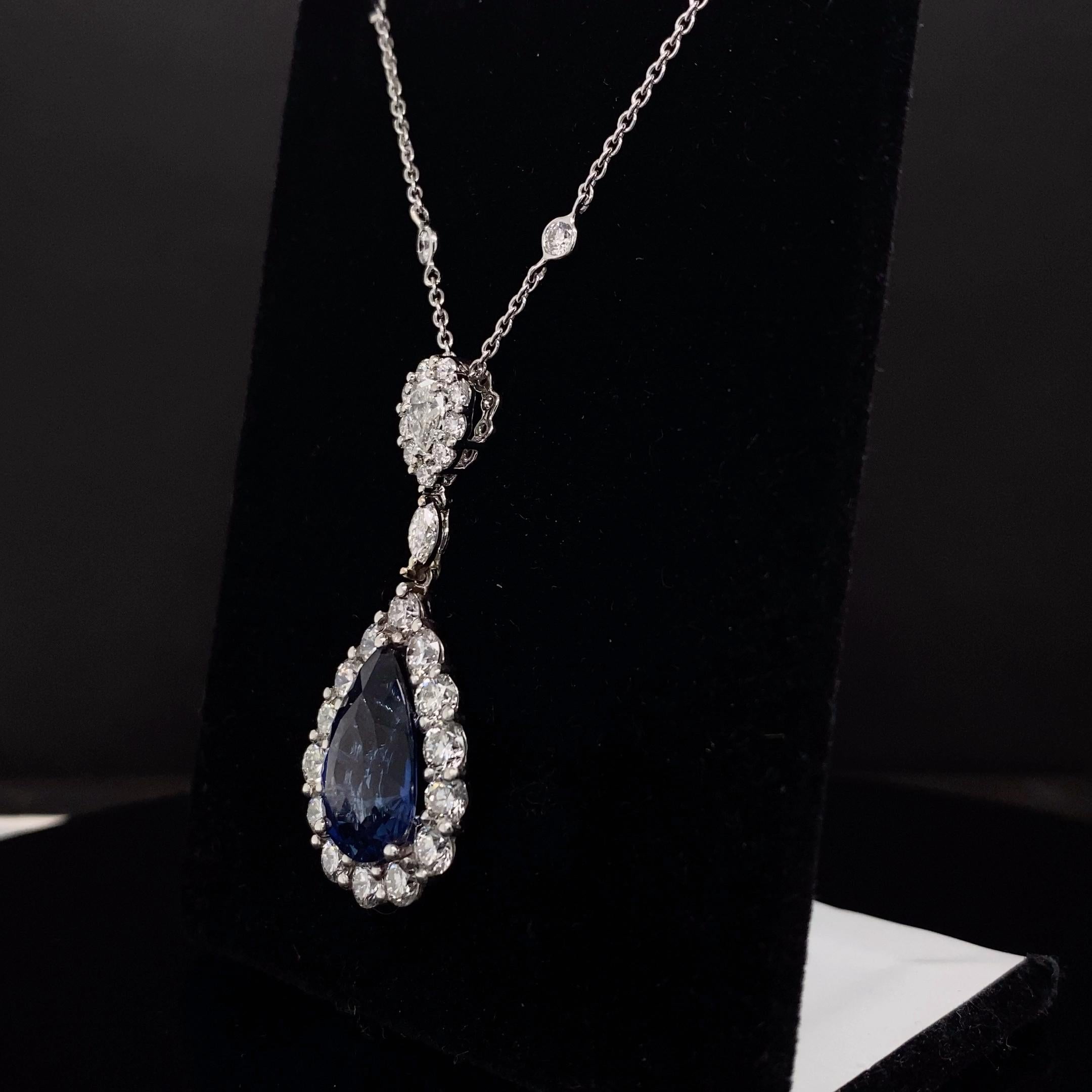 Una classica collana con ciondolo che mette in mostra uno zaffiro blu a forma di pera del peso totale di 7,03 carati. Impreziosito da una fila di diamanti rotondi, per un peso totale di 3,85 carati. Sospeso su un'aureola di diamanti a forma di pera
