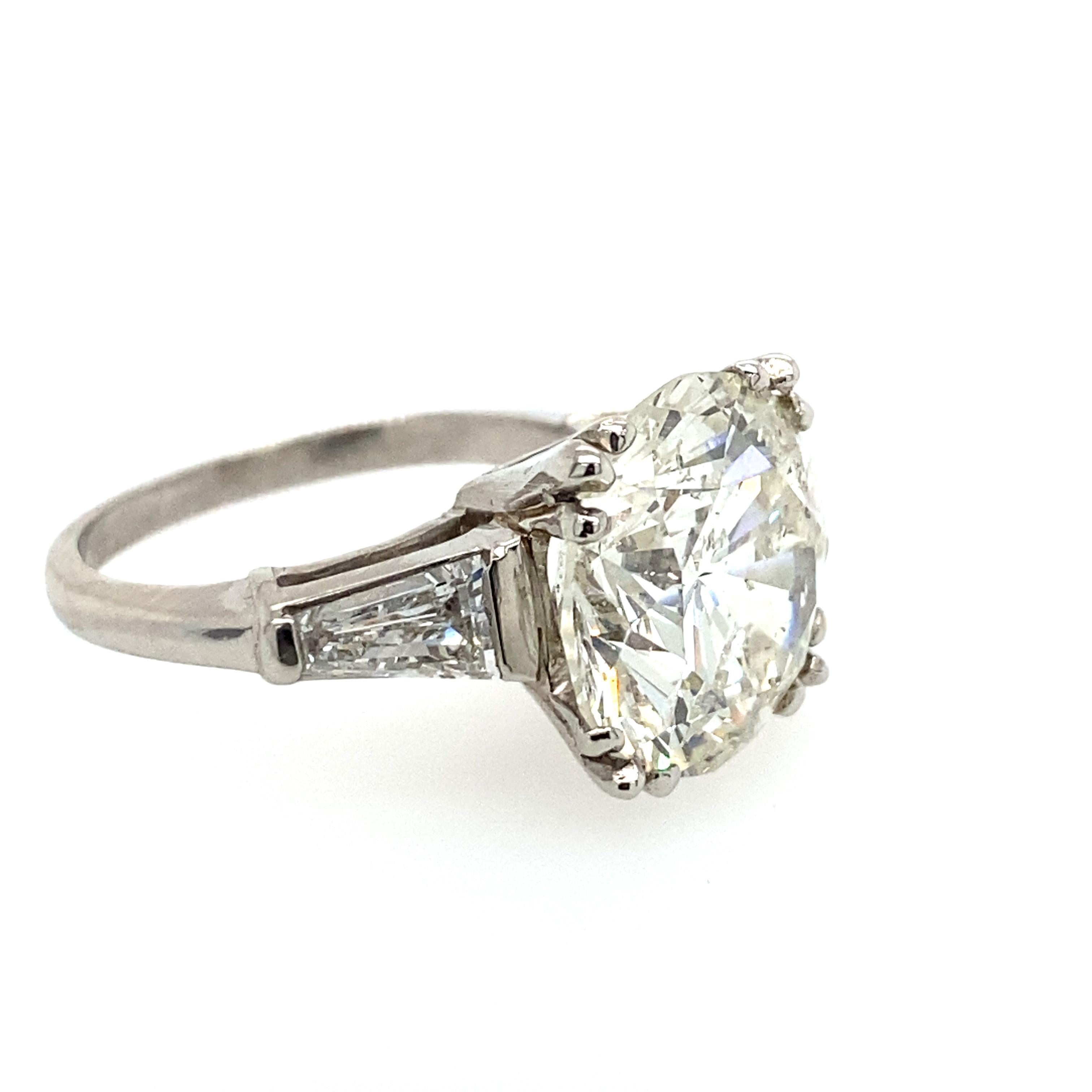 One fabulous 7.04carat diamond. The center diamond is round brilliant cut. It measures 12.19x12.26x7.66mm. The diamond has J-K color and I1 Clarity, it faces up extremely white and has some tiny white inclusions that can be seen with the unaided