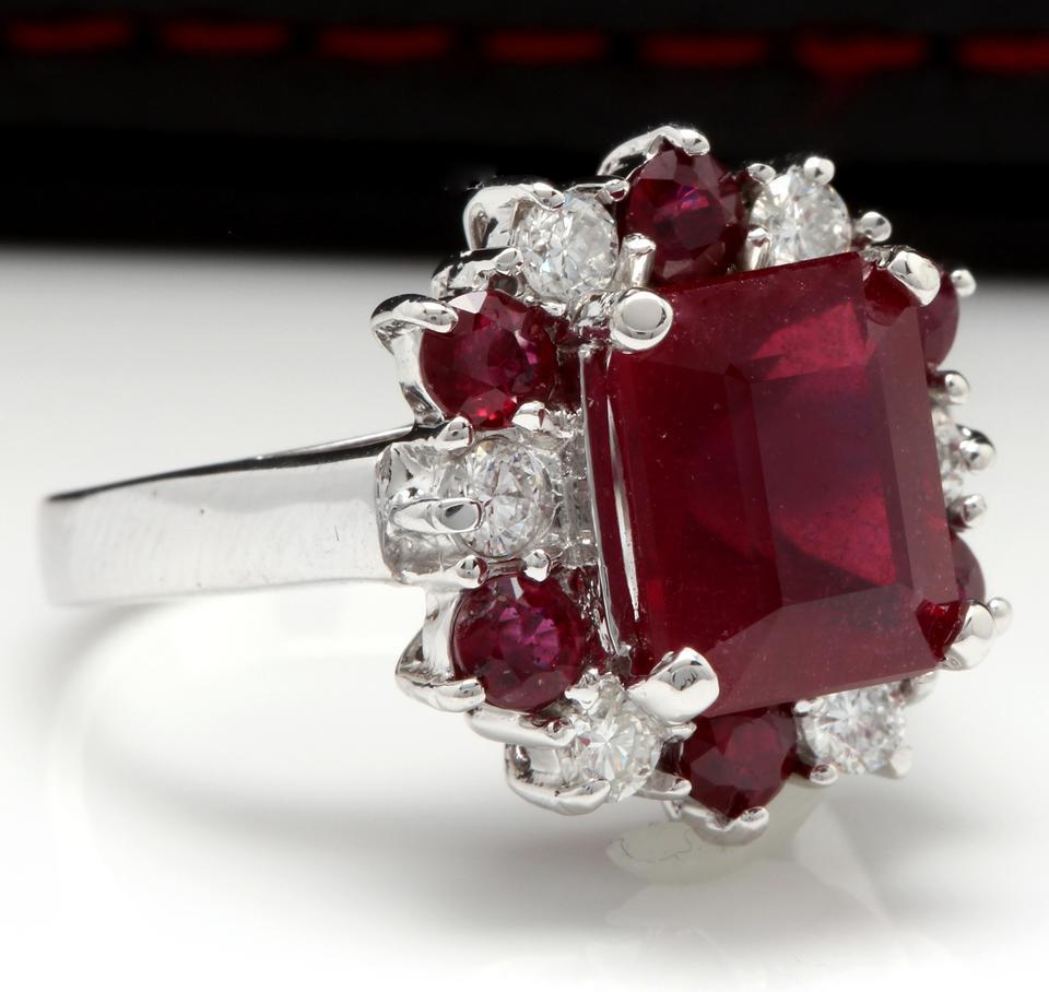 7.05 Carats Impressive Natural Red Ruby and Diamond 14K White Gold Ring

Total Emerald Cut Center Red Ruby Weight is: Approx. 5.50 Carats (Lead Glass Filled)

Center Ruby Measures: Approx. 9.82 x 8.04mm

Side Natural Rubies Weight is: Approx. 1.05