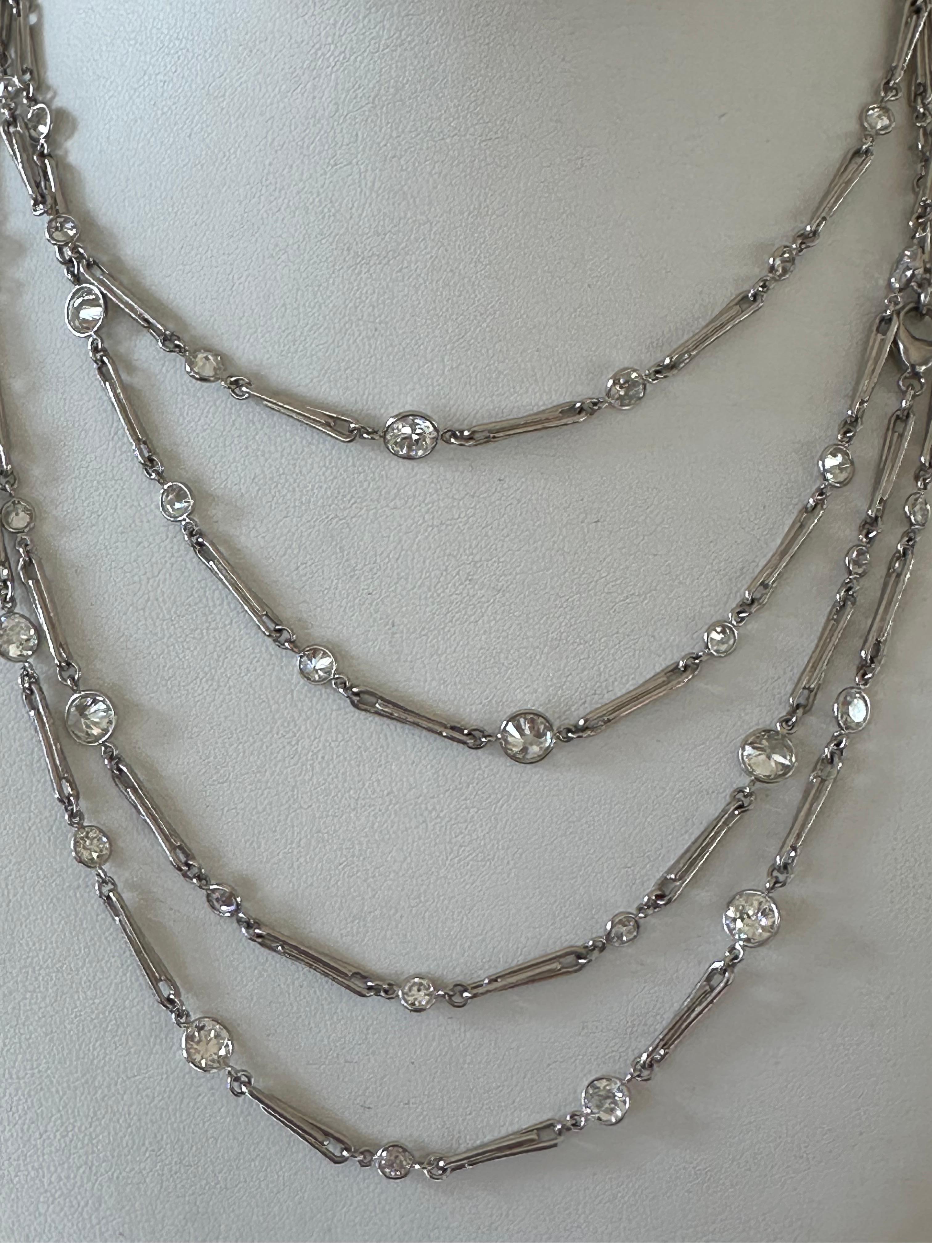 Measuring an impressive 70.5 inches long, this antique style diamonds-by-the-yard necklace features seventy-five Old European cut diamonds in varying sizes, GH color, VS clarity, weighing together 24.35 carats. Handcrafted in platinum.  As versatile