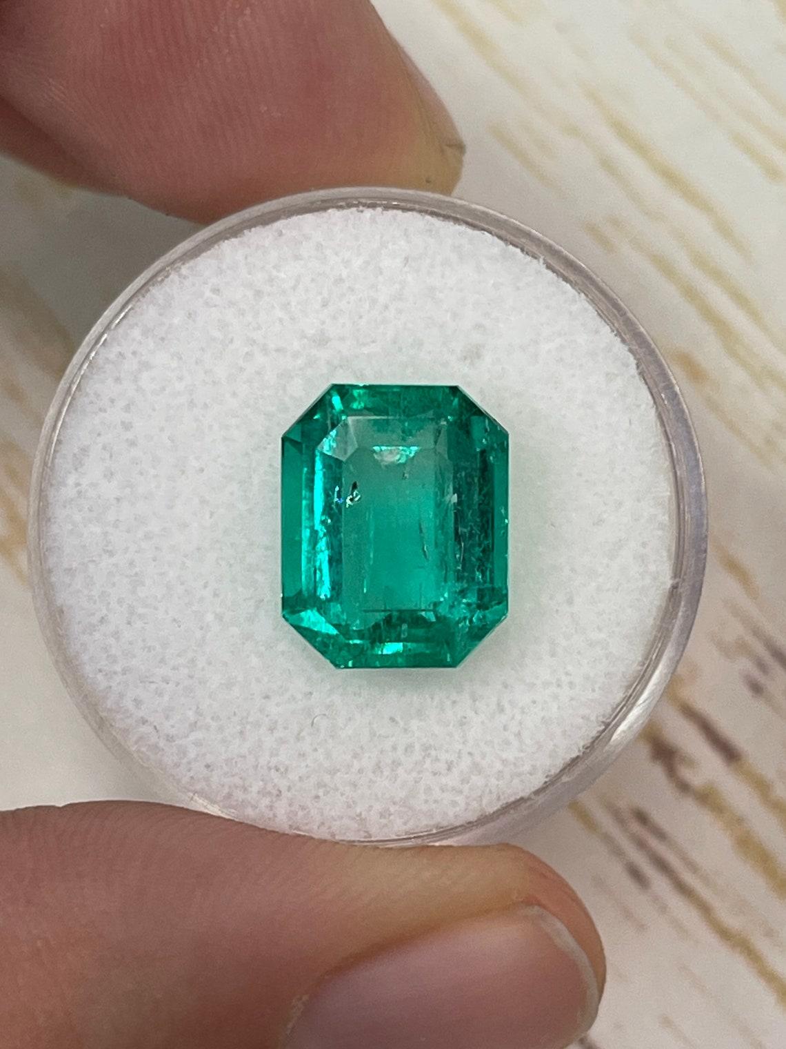 Stone: Emerald
Weight: 7.06-carats
Shape: Emerald Cut
Clarity: Transparent
Luster: Excellent-Very Good
Color: Intense Bluish Green
Measurements: 11.79mm x 9.53mm x 7.72mm
Geographic Origin: Colombia
Treatment: Natural, Oiling

Comments: Due to their