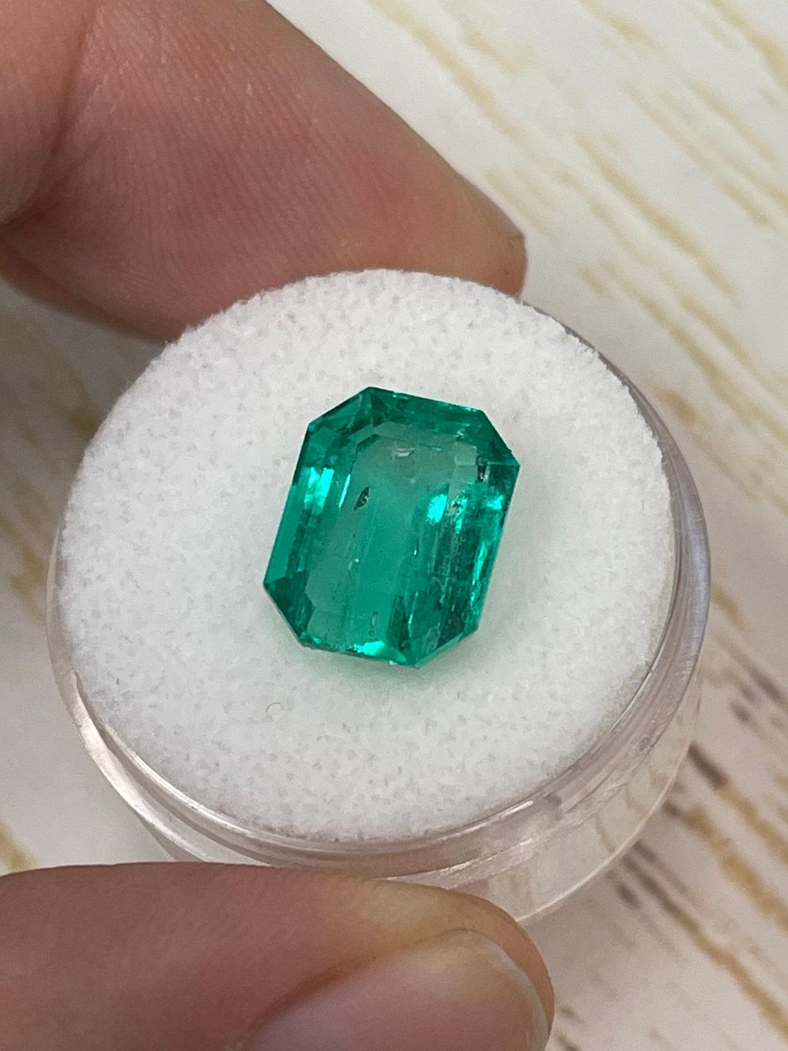 Women's 7.06 Carat 12x9.5 Glowing Bluish Green Colombian Emerald - Emerald Cut Muzo Mine For Sale