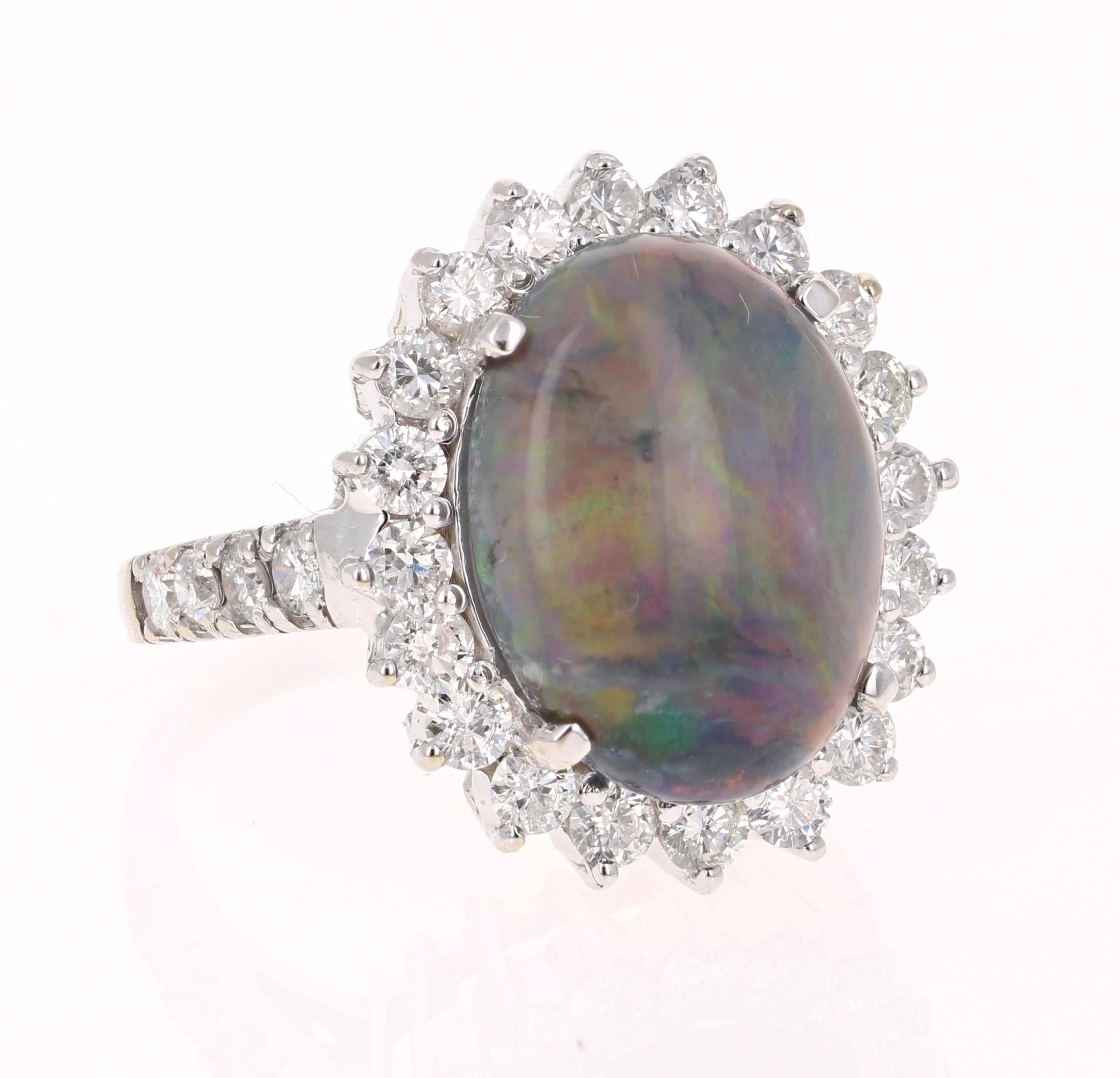 One of A Kind Opulent Black Opal Diamond Ring! 

This ring has a 5.49 Carat Opal that is curated in a classic 14 Karat White Gold setting. The setting is adorned with 28 Round Cut Diamonds that weigh 1.57 Carats. The total carat weight of the ring