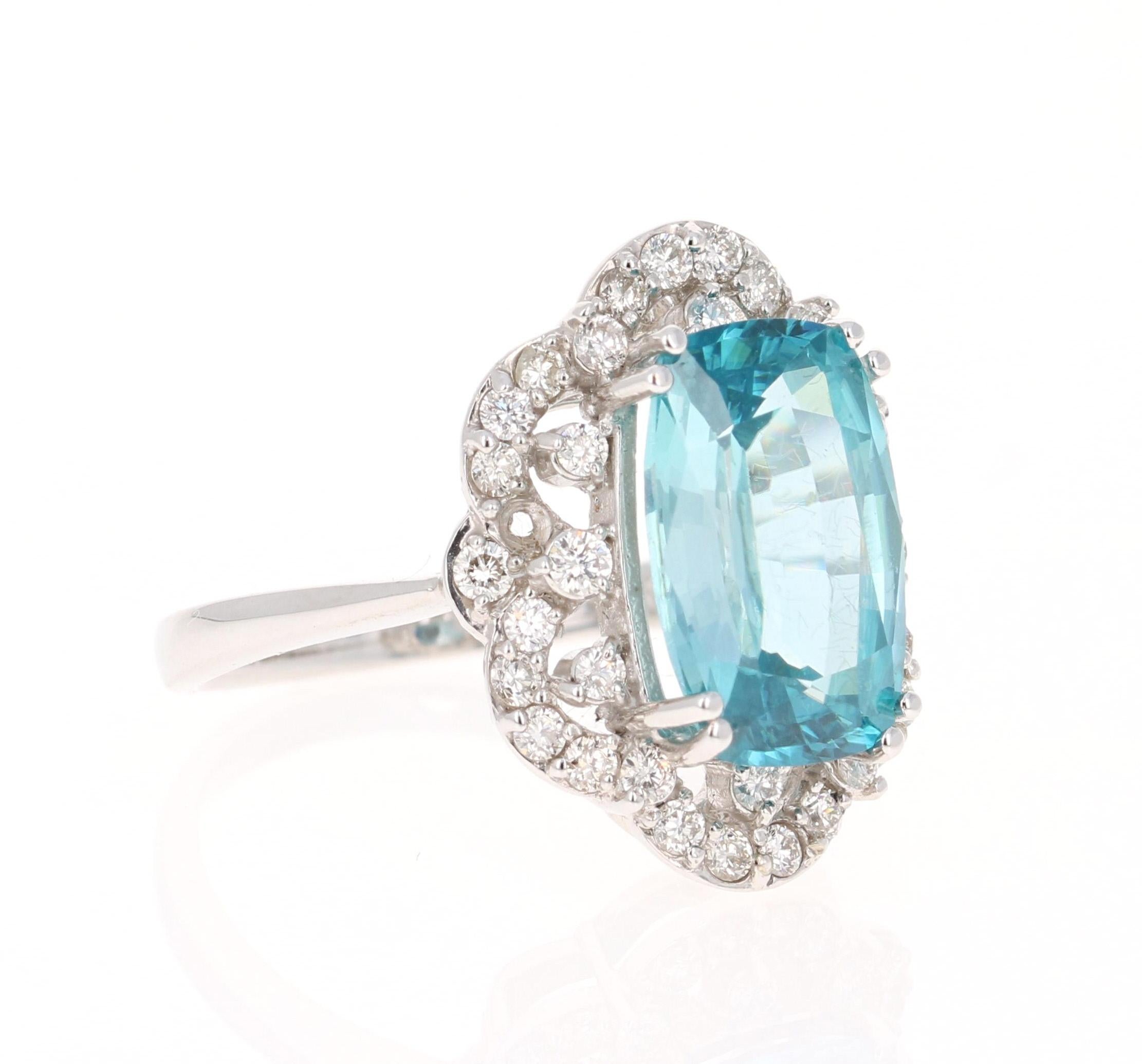 A beautiful Blue Zircon and Diamond ring that can be a nice Engagement ring, an Everyday Ring or even a Cocktail Ring!
Blue Zircon is a natural stone mined mainly in Sri Lanka, Myanmar, and Australia.  
This ring has striking Oval/Cushion Cut Blue