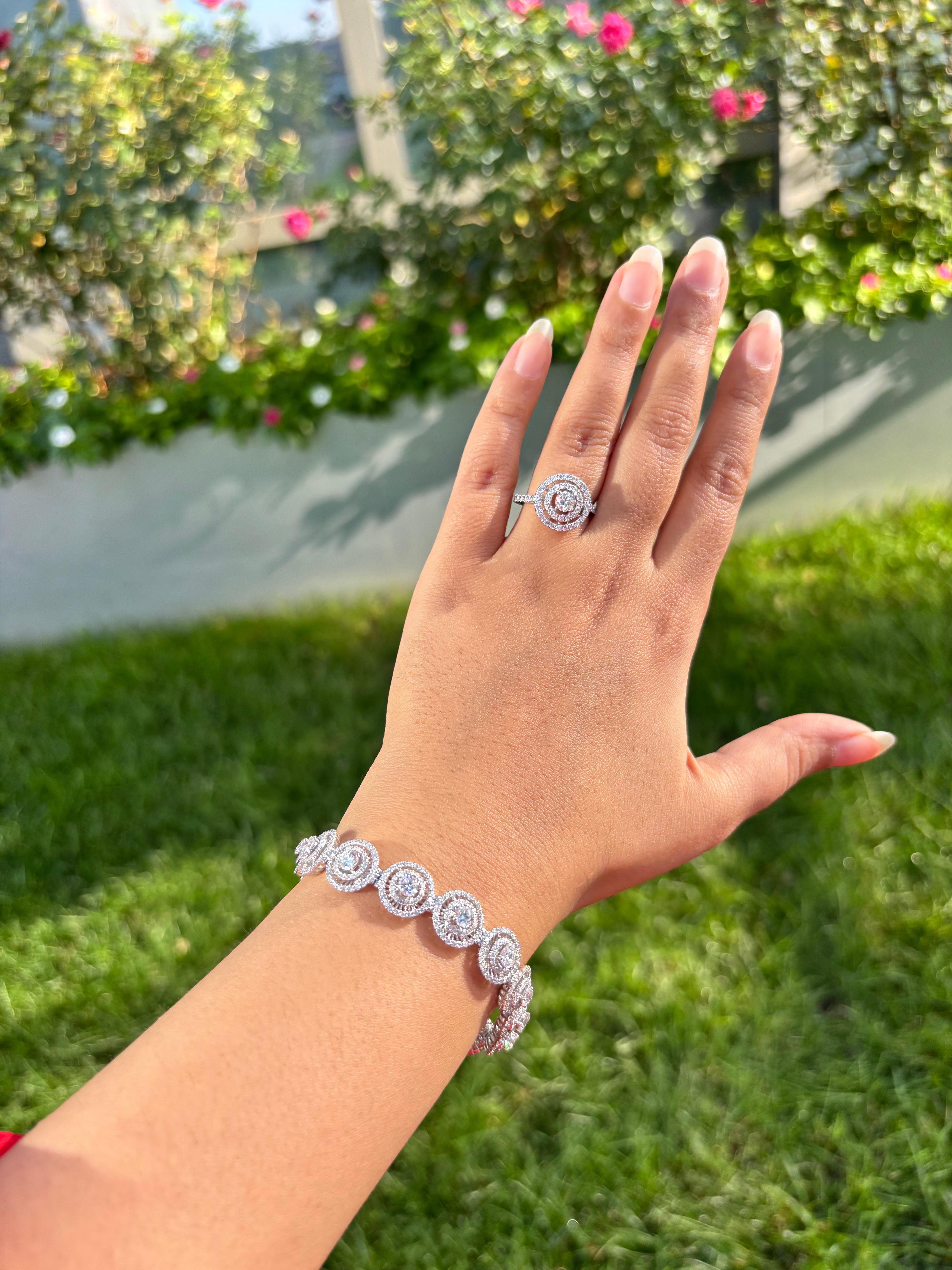 ROUND - 3.320 CARATS (645PCS)
ROUND - 3.740 CARATS (15 PCS 0.25 CARAT EACH)
GROSS WEIGHT 19.340 GRAMS 14KT WHITE GOLD

Indulge in the allure of our exquisite tennis bracelet, where elegance meets sophistication. Featuring mesmerizing double halos,