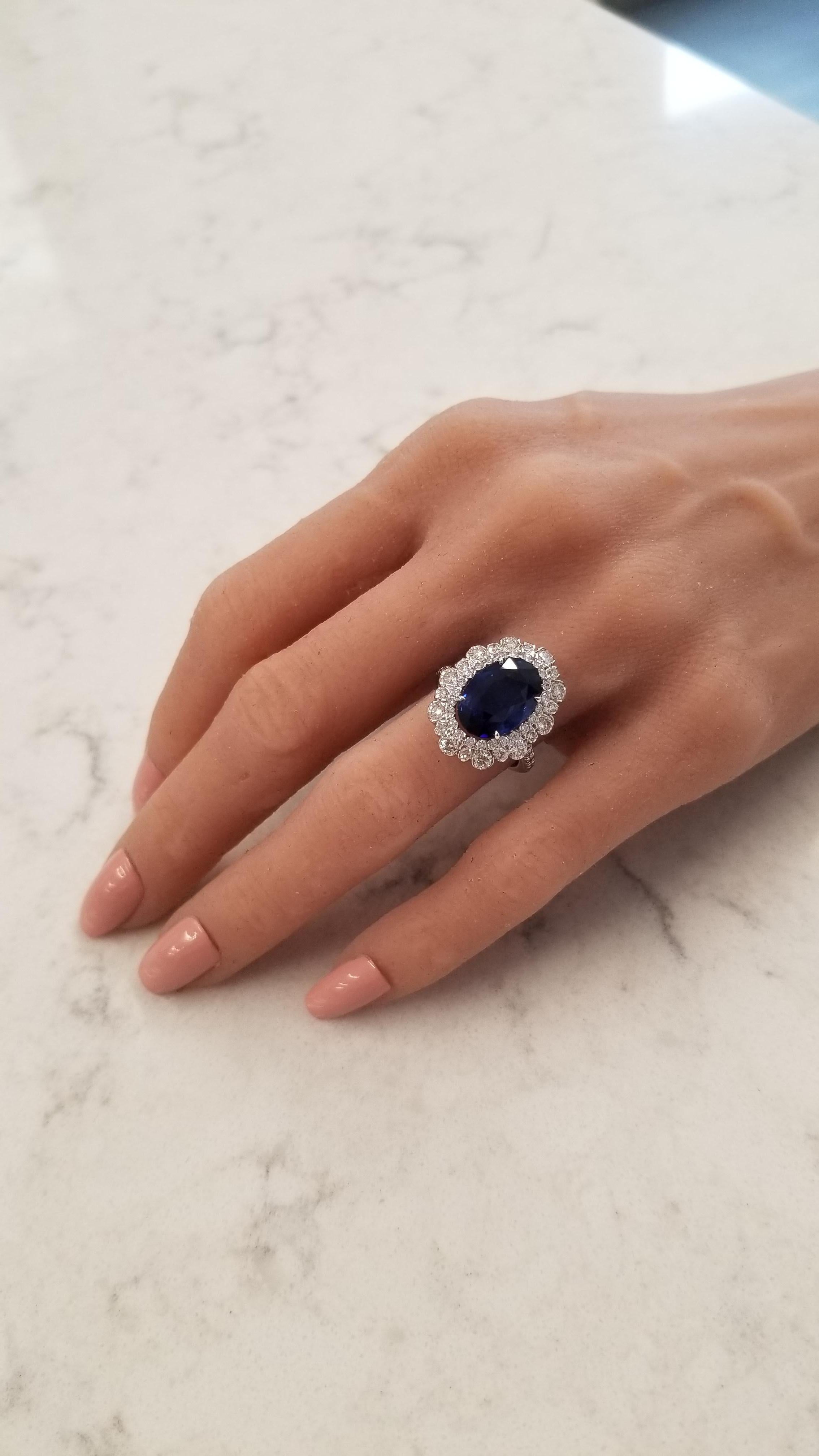 This is an intense royal blue sapphire weighing 7.06 carats and measures 13.58 X 9.21mm. The gem source is Sri Lanka. Its color is royal blue, except this one is more distint. Its material is velvet blue. Its framed by a total of 1.78 carats of