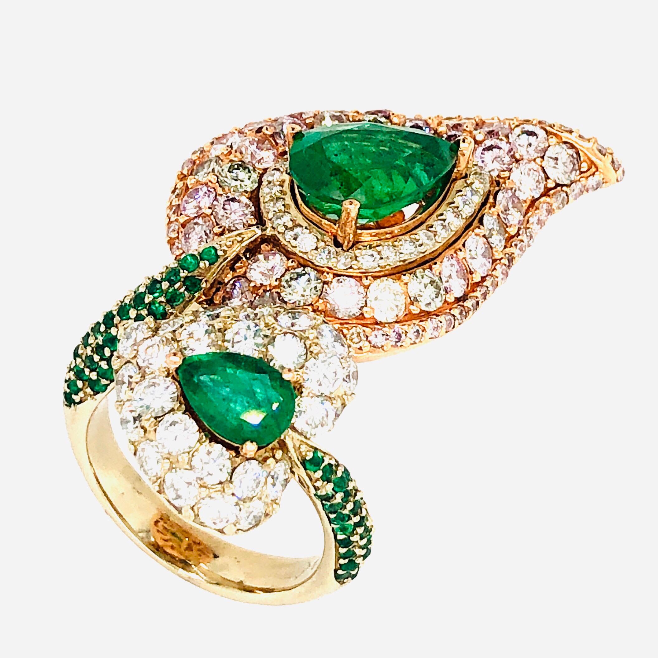 Offered here is gorgeous leaf ring with natural pink diamonds, white diamonds, green diamonds and natural emeralds all set in 18kt rose and white gold. The ring has two ( 2 ) emerald pear shape, the big one weighs about 2.25 carat and the smaller