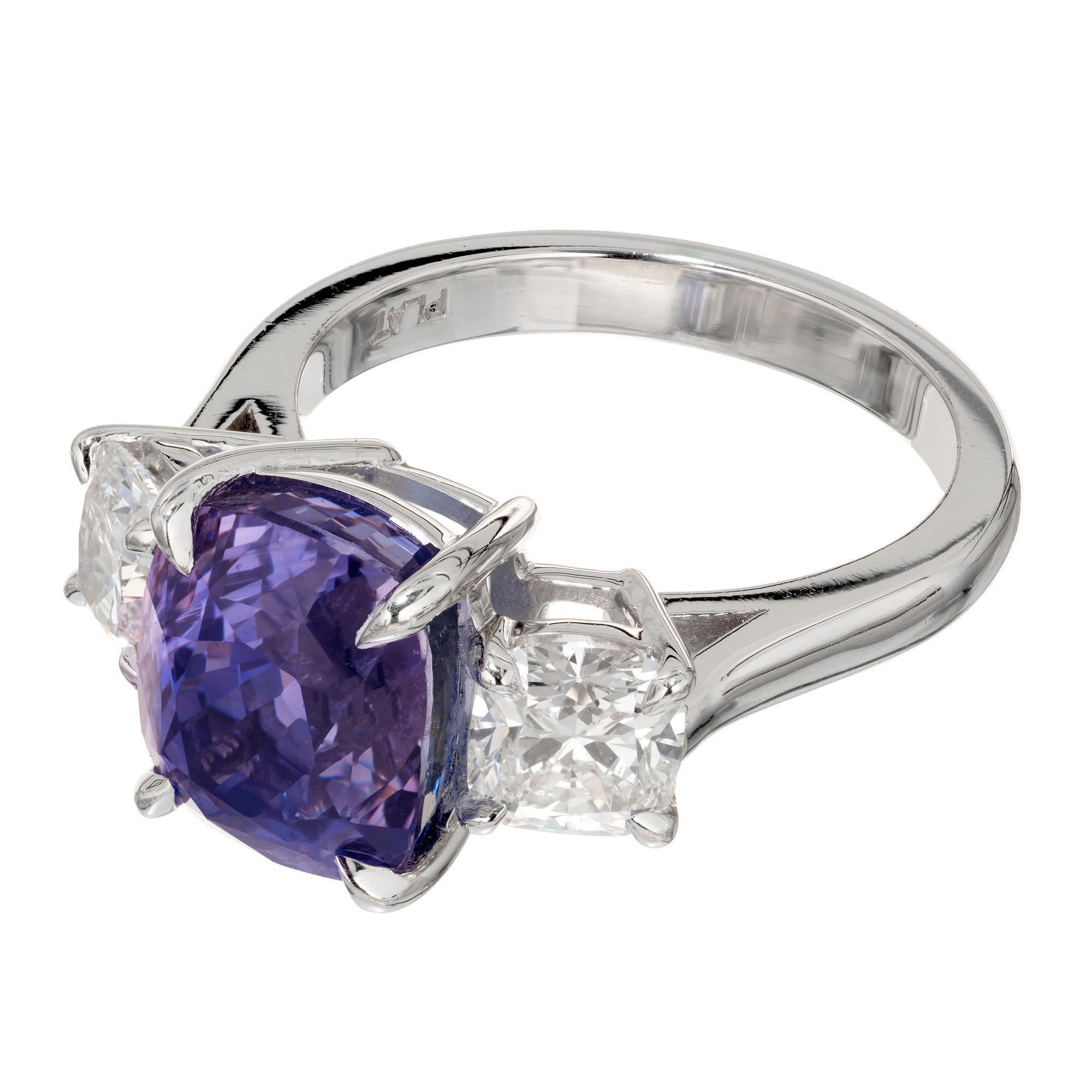 Natural color change 7.06ct cushion cut Sapphire and diamond engagement ring. GIA certified to change color from violet to purple in different light. Accented with 2 antique cushion cut diamonds in a platinum three-stone setting.

1 antique cushion