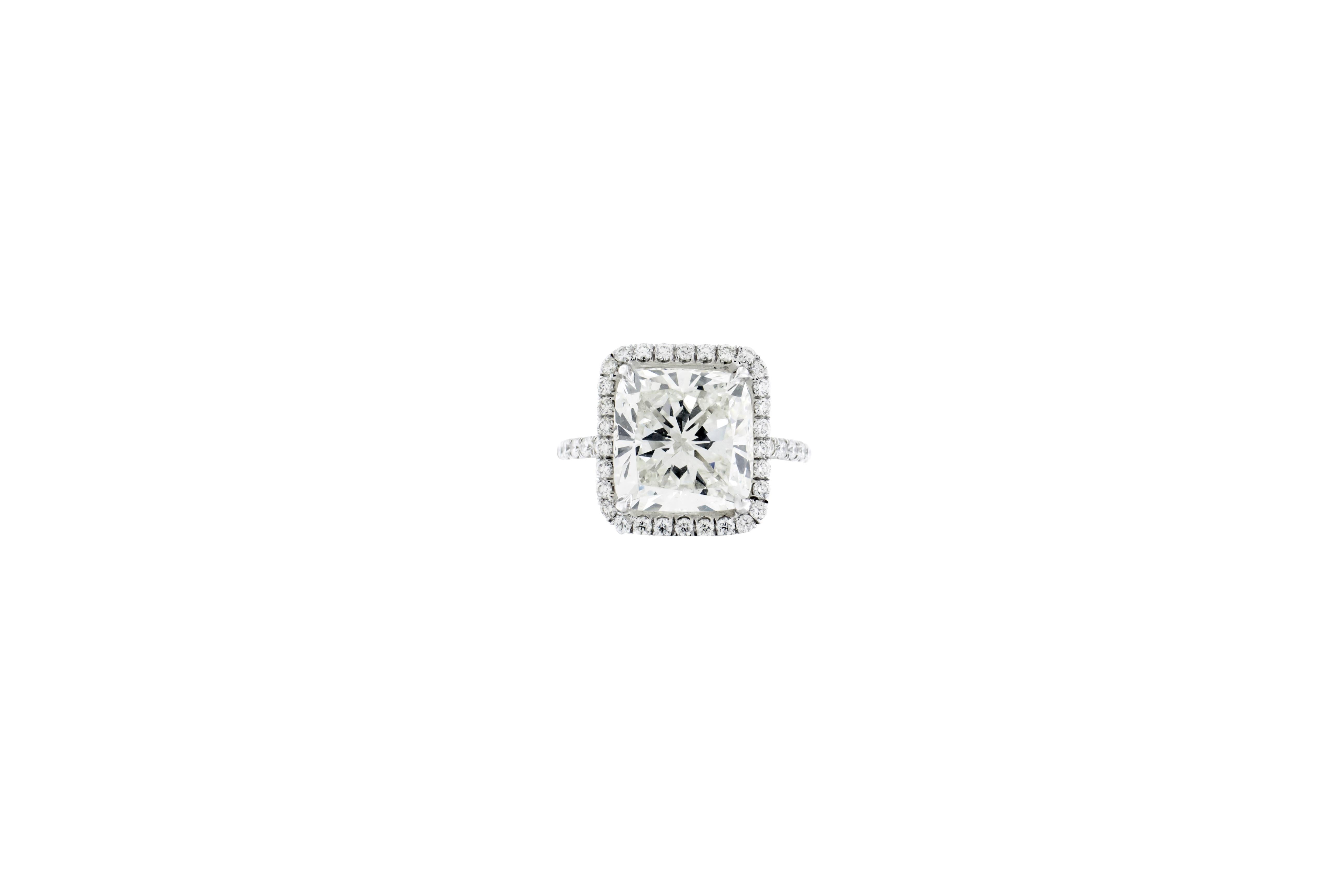 A 7.06 modified brilliant cushion cut diamond, K VS2,  set in platinum and 18K white gold with a micro-pave halo of diamonds G-H color VS-SI. Setting has a total of 30 stones. GIA certified. Certificate No. 1136243398. Size 7 1/4.

Resizing