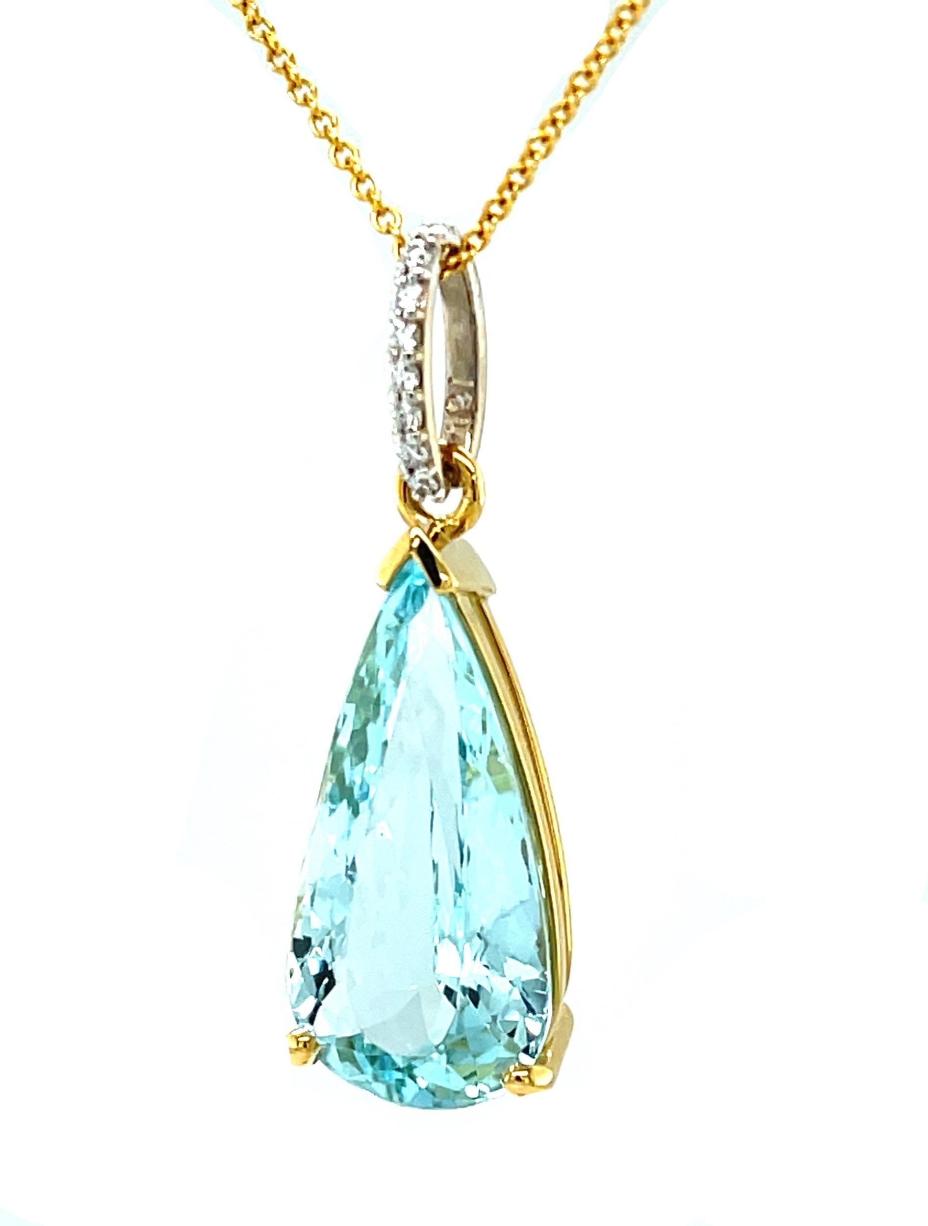 This gorgeous aquamarine and diamond necklace features an impressive 7.07 carat pear-shaped aquamarine set in 18k yellow gold. The aquamarine is a beautifully crystalline gem with bright blue color and exceptional brilliance. Accented with a