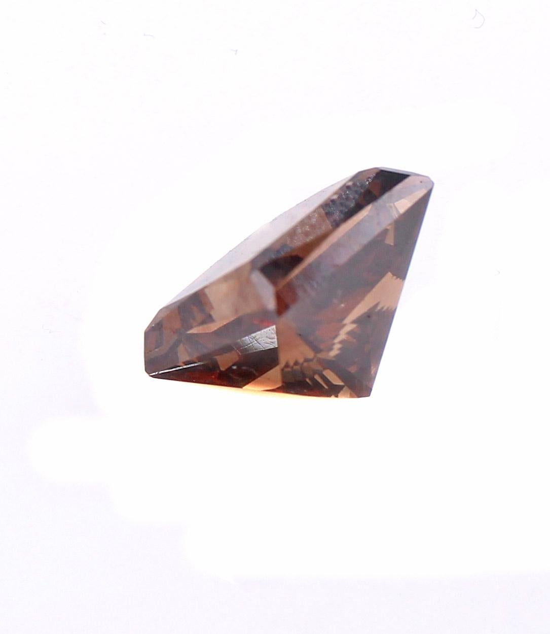 This perfectly cut 7.07 carat princess cut diamond displays a wonderful chocolate brown color with a hue of orange. Accompanied by a report from the GIA stating that the natural fancy color diamond is graded as Fancy Dark Orange-Brown with a clarity