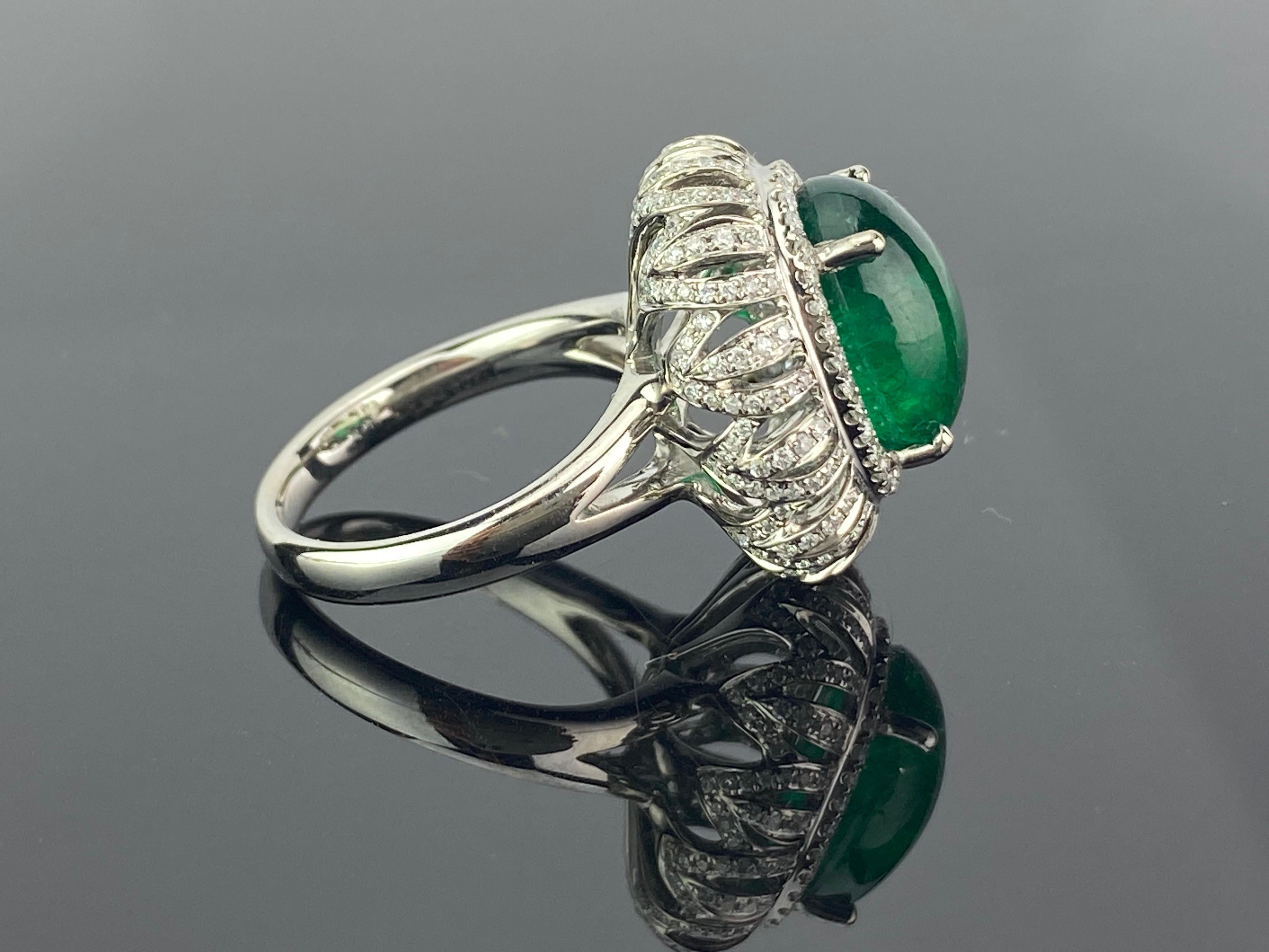 A beautiful 7.09 carat Zambian Emerald Ring with Diamonds, all set in 18K white gold. The Emerald is completely transparent, with stunning lustre and deep colour. The pictures depict the actual colour/quality of the centre stone. Currently a ring