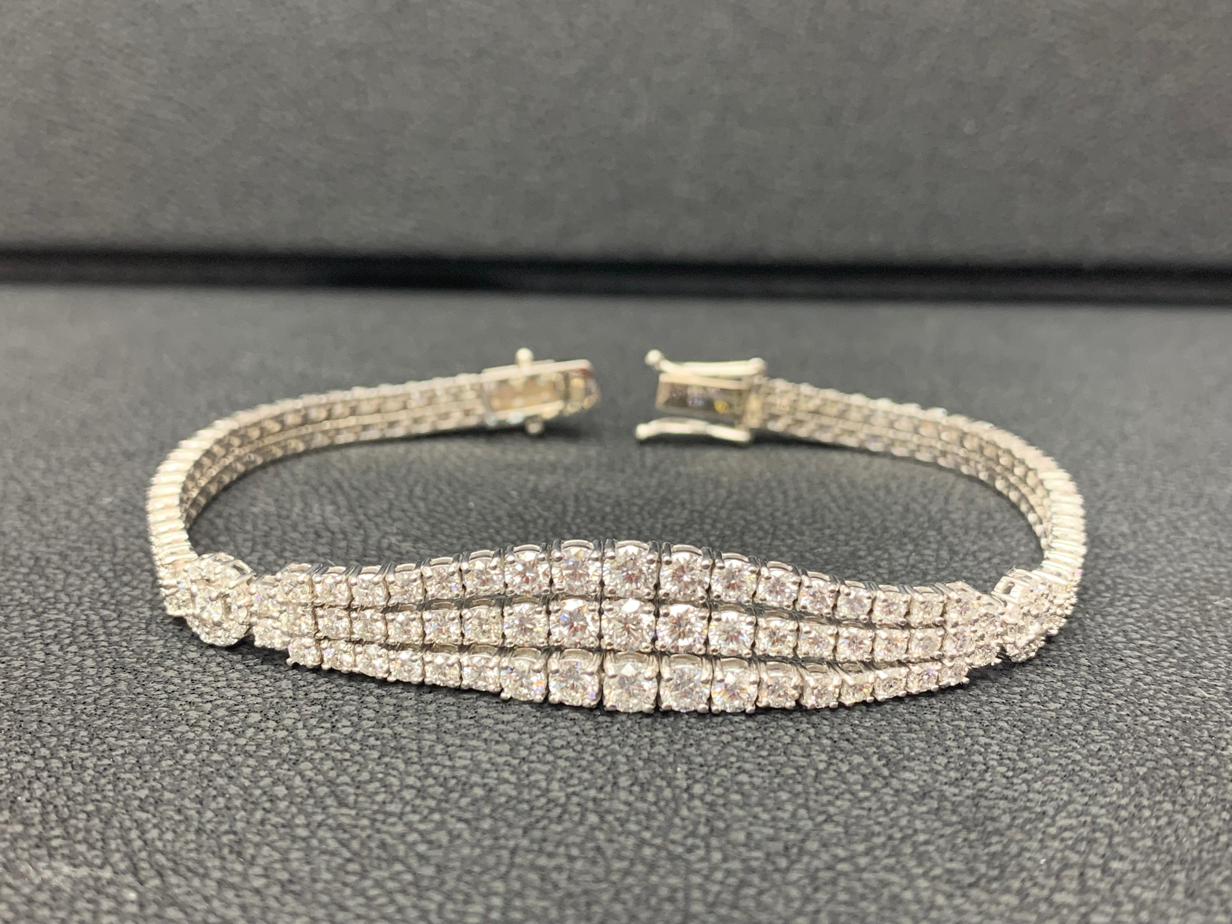 A fashionable and beautiful bracelet showcasing three-rows of  179 brilliant cut  round shape diamonds that graduate larger as it gets to the center. Diamonds weigh 7.09 carats total.  Made in 14k white gold.