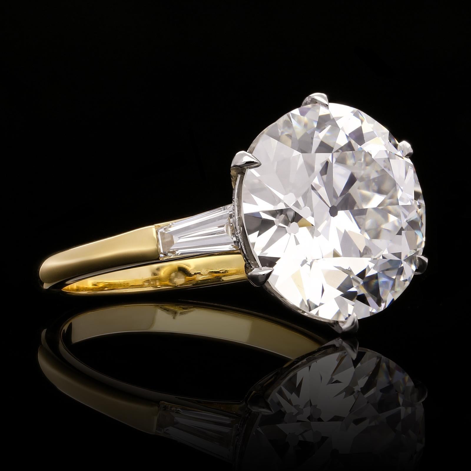A stunning old cut diamond solitaire ring by Hancocks set with a beautiful bright and lively old European brilliant cut diamond weighing 7.09ct and of G colour and VS1 clarity claw set to a finely crafted handmade platinum and gold mount, the