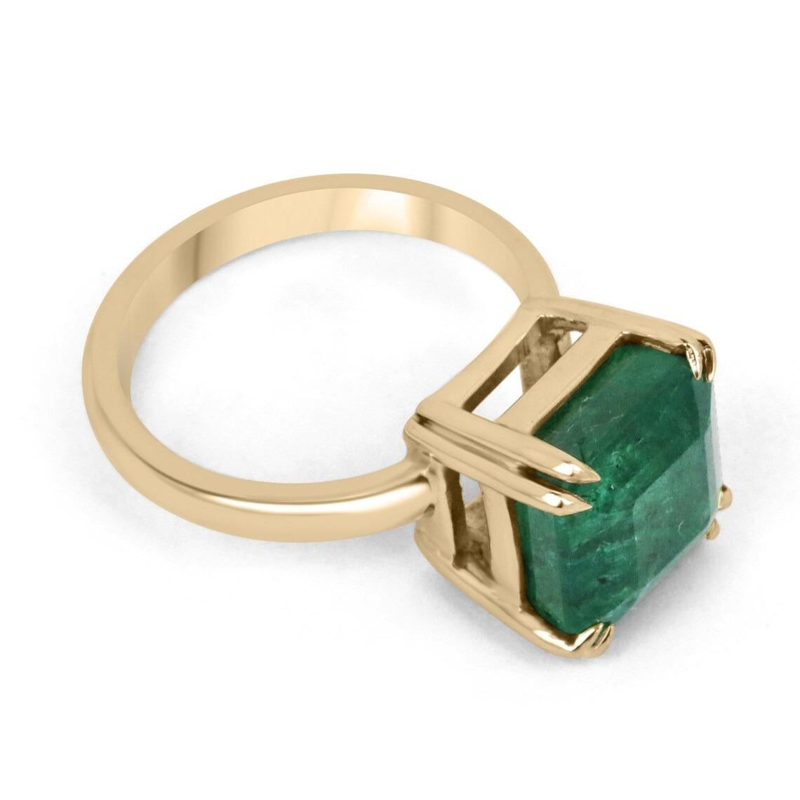 Displayed is a 7.0-carat classic emerald solitaire, Asscher-cut, engagement, or right-hand ring in 18K yellow gold. This gorgeous solitaire ring carries an earth-mined emerald in a secure double-prong setting. Fully faceted, this gemstone showcases