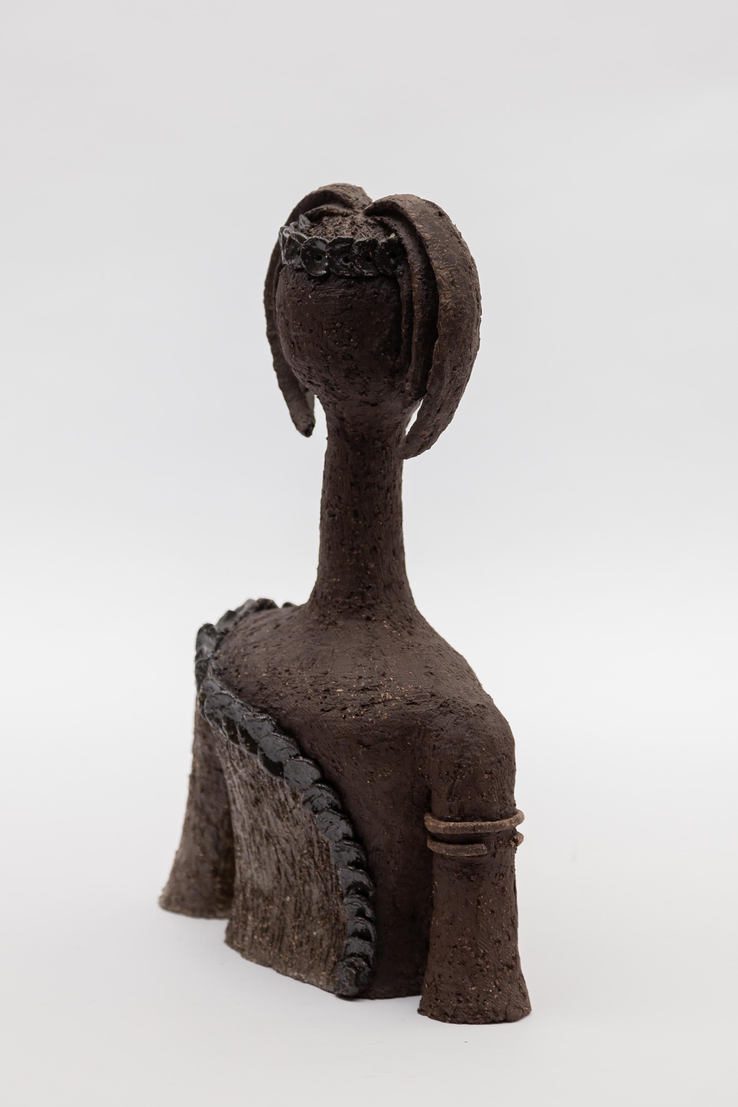 Ceramic female sculpture bust of an abstract girl, 1970s of an unknown Belgium Artist. The Bust is modeled by hand from dark coarse clay and glazed.