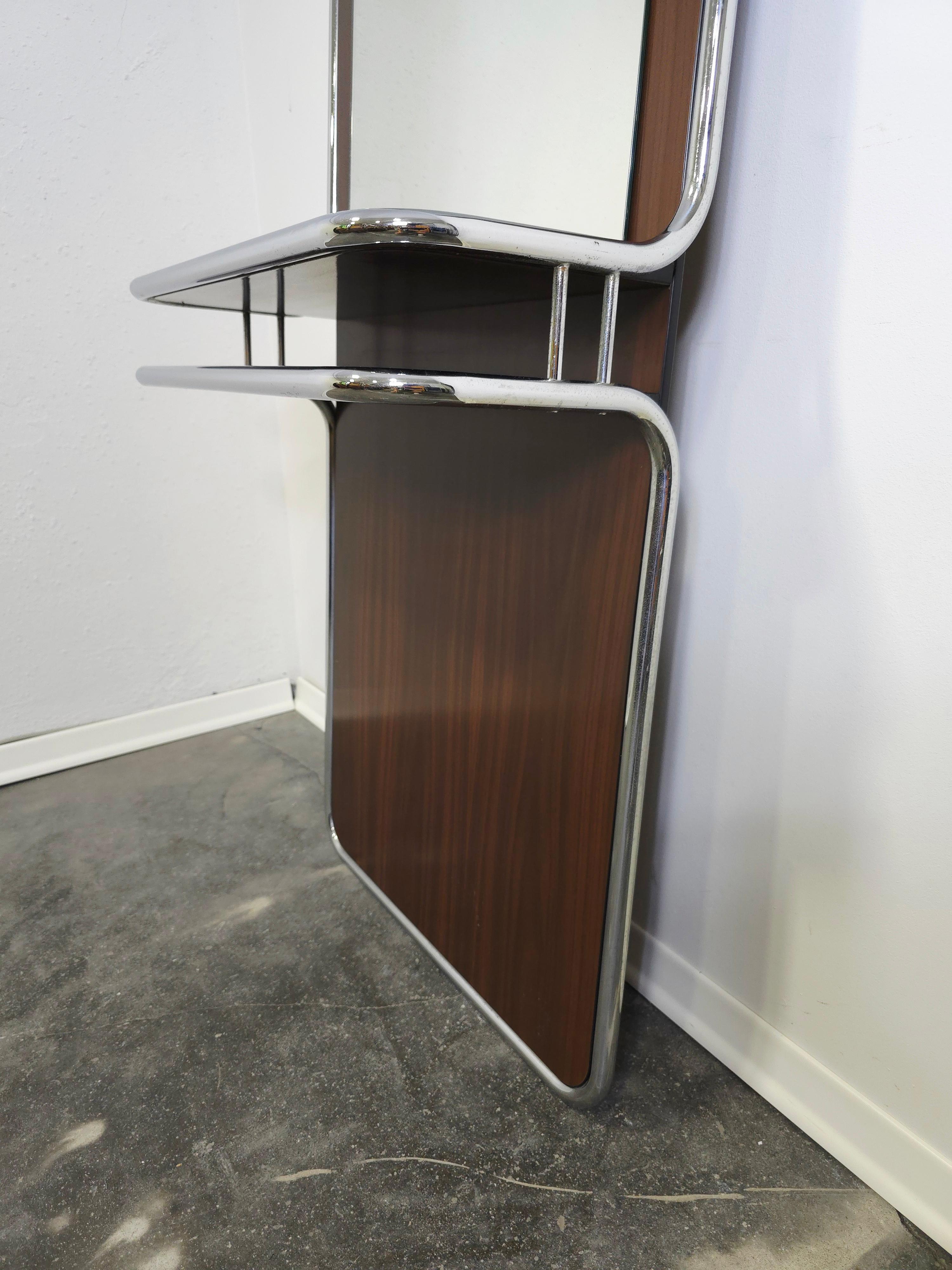 Raro e ben conservato specchio da parete originale in stile Bauhaus degli anni '70 - una splendida combinazione di cromo industriale e caldo legno di noce, progettato tenendo conto sia dell'estetica che della funzionalità.

Telaio: tubolare in