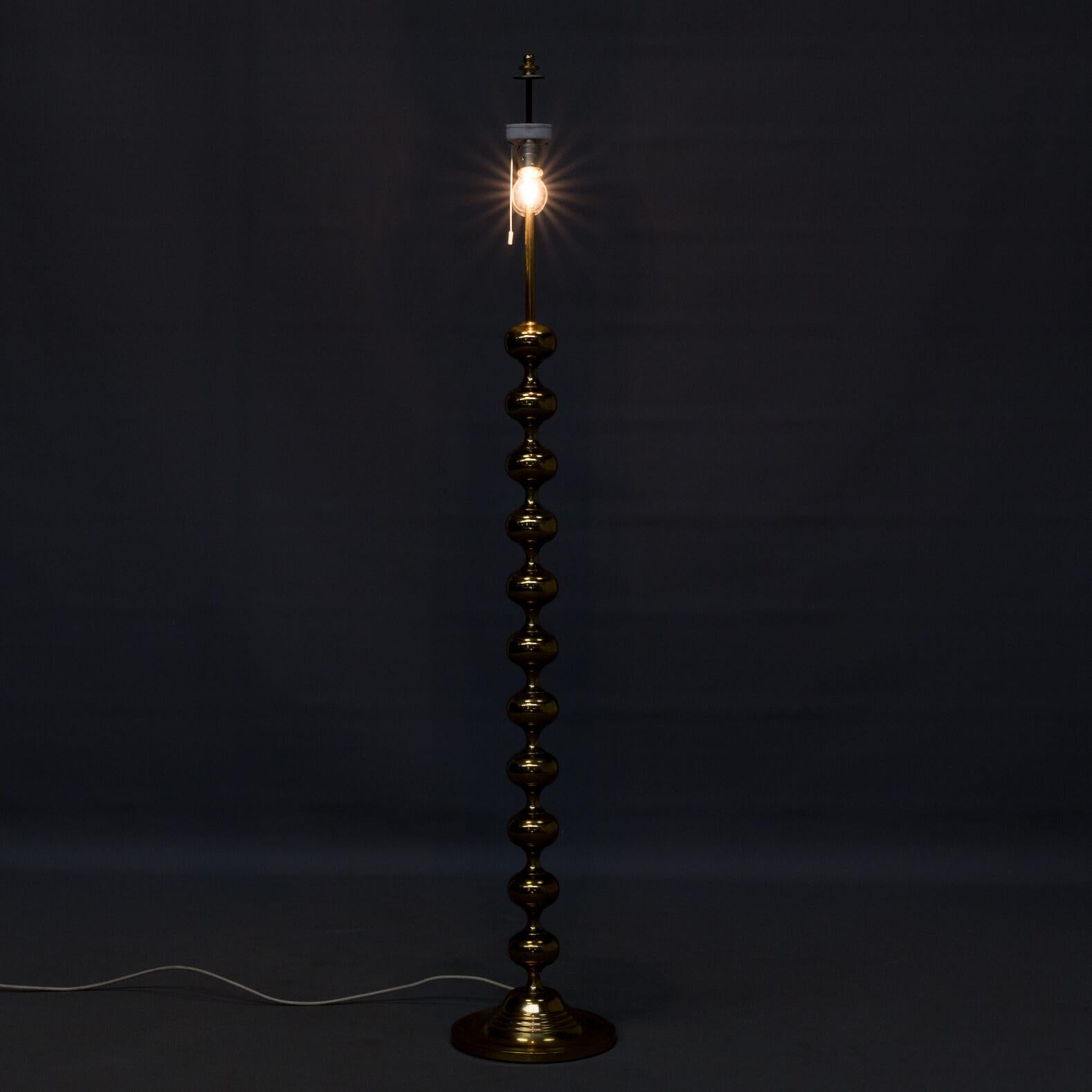 1970s brass floorlamp foot for Kaiser Leuchten, double switch. German company Kaiser Leuchten designed a range of floorlamps with piled round shapes. Well known are the ceramic designs, this piece is in polished brass and has two bulbs. Hoods can be