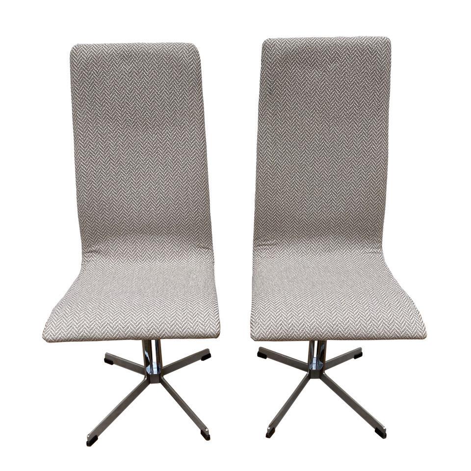 This pair of British mid-century Mod chairs with chrome bases has the sleek style and minimal design reminiscent of the work of Milo Baughman. The tall shaped backs make them comfortable while enhancing the overall verticality of the design. Newly