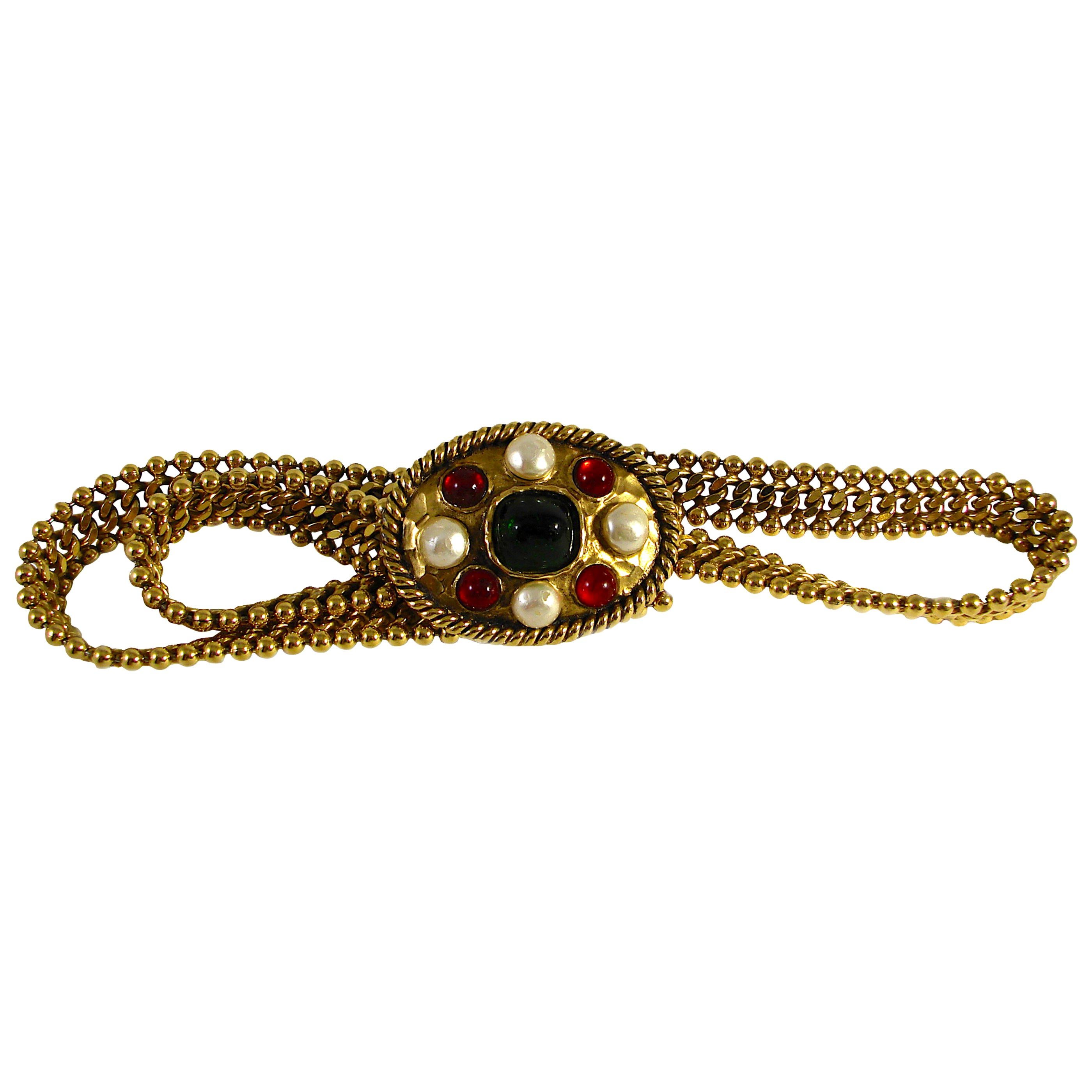This fabulous belt was made by Robert Goossens for Chanel in the early 1970s and was acquired from the estate of a former Chanel employee. Made from gilt metal, the buckle features red & green pâte de verre (poured glass) stones with four cream