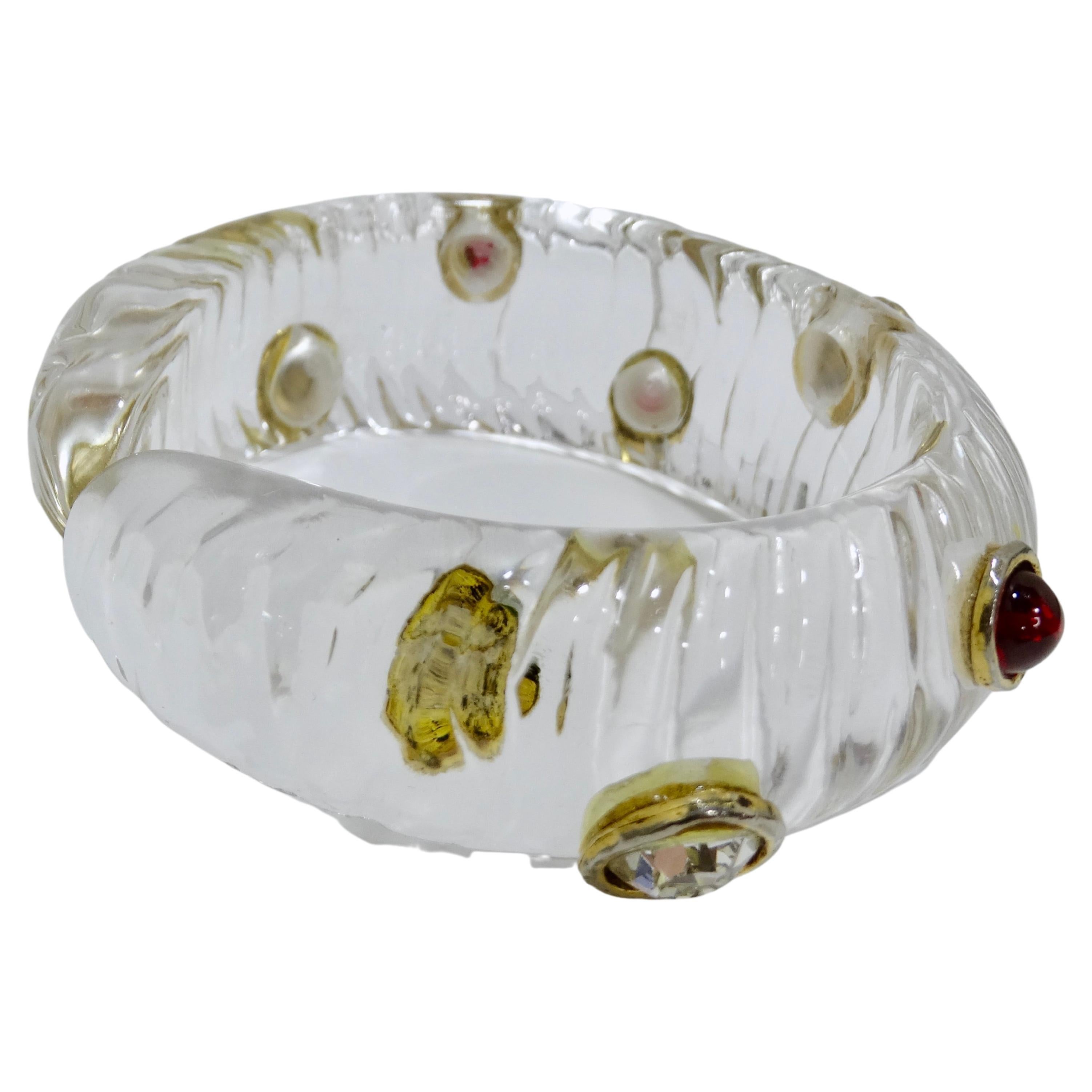 This vintage Chanel cuff will take you right back to the 70's and not in a bad way. Accessorize the right way by adding a little oomph to your outfit with a beautiful and unique cuff. This item features details like clear Lucite and Gripoix glass