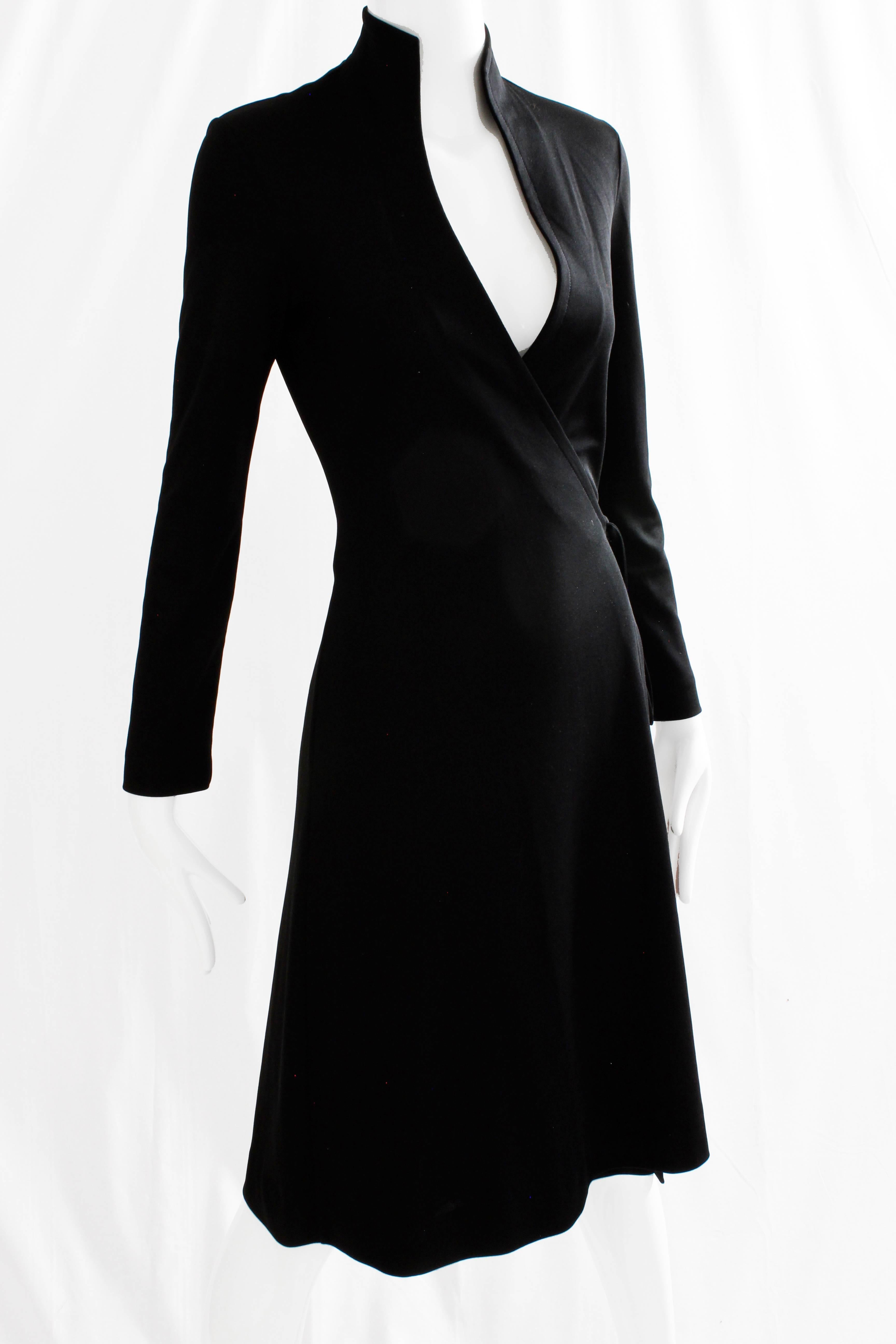 This chic little black dress was made by Clovis Ruffin for his Ruffinwear line, most likely in the late 1970s.  Made from a black knit jersey fabric, it features a true wrap design with a swan neck collar.  Simple and sophisticated, it's perfect for