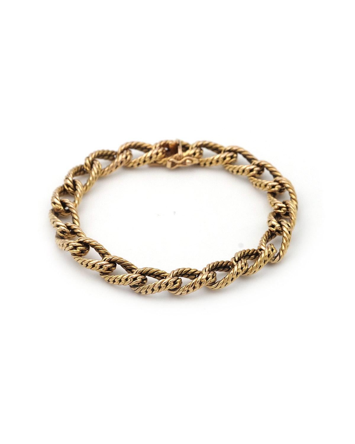 70s curb chain bracelet in 18 karat textured gold. A bracelet reminiscent of the Hermès style of the 1970s, featuring a textured curb chain with a herringbone weave. A vintage bracelet, circa 1970, France.

Eagle head hallmark, rhinoceros hallmark